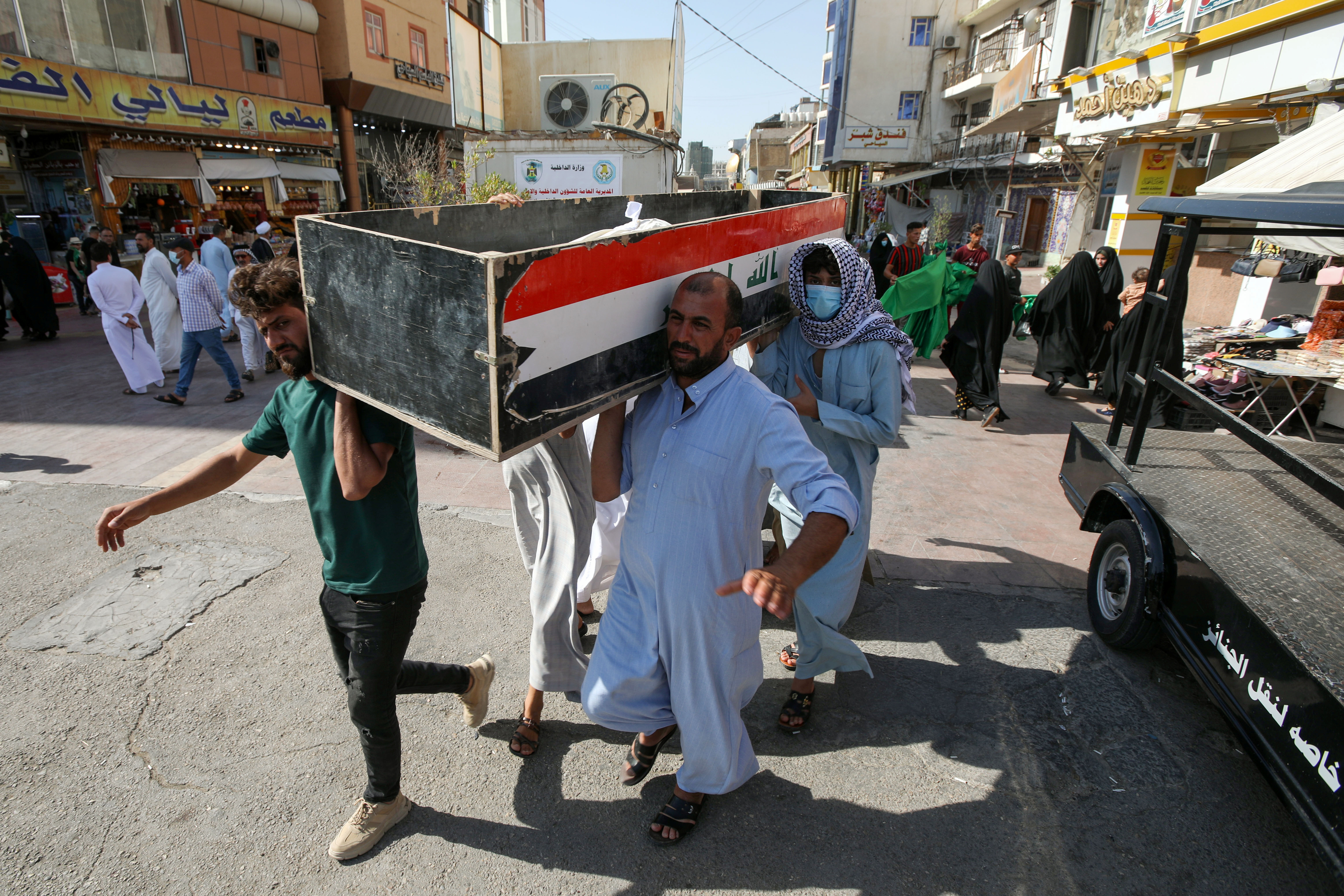 Mourners carry the coffin of a victim, who was killed in a fire that broke out at al-Hussain coronavirus hospital in Nassiriya, during a funeral in Najaf, Iraq, July 13, 2021. REUTERS/Alaa Al-Marjani