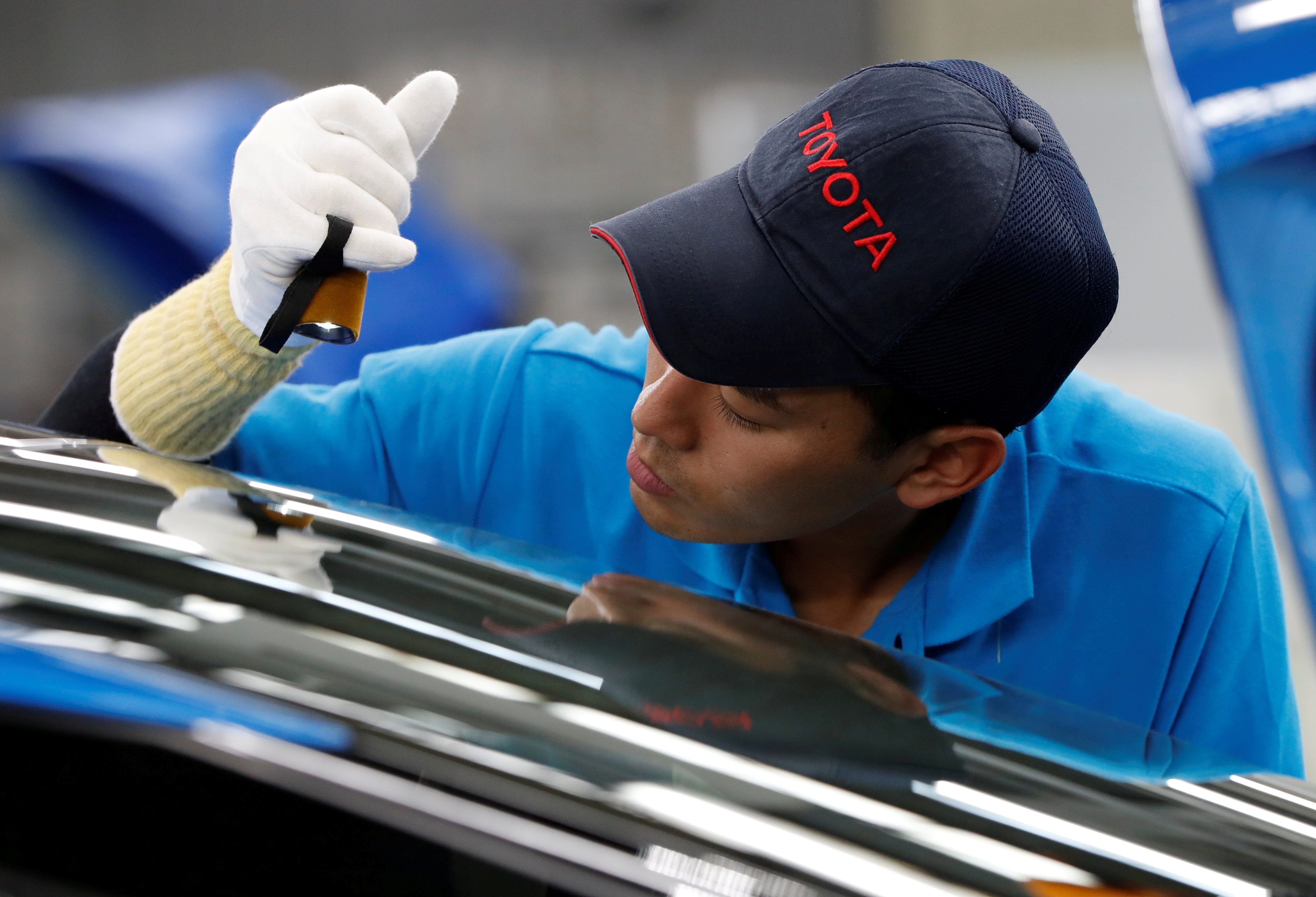 An employee of Toyota Motor Corp. works on the assembly line of Mirai fuel cell vehicle (FCV) at the company's Motomachi plant in Toyota, Aichi prefecture, Japan May 17, 2018. Picture taken May 17, 2018.  REUTERS/Issei Kato