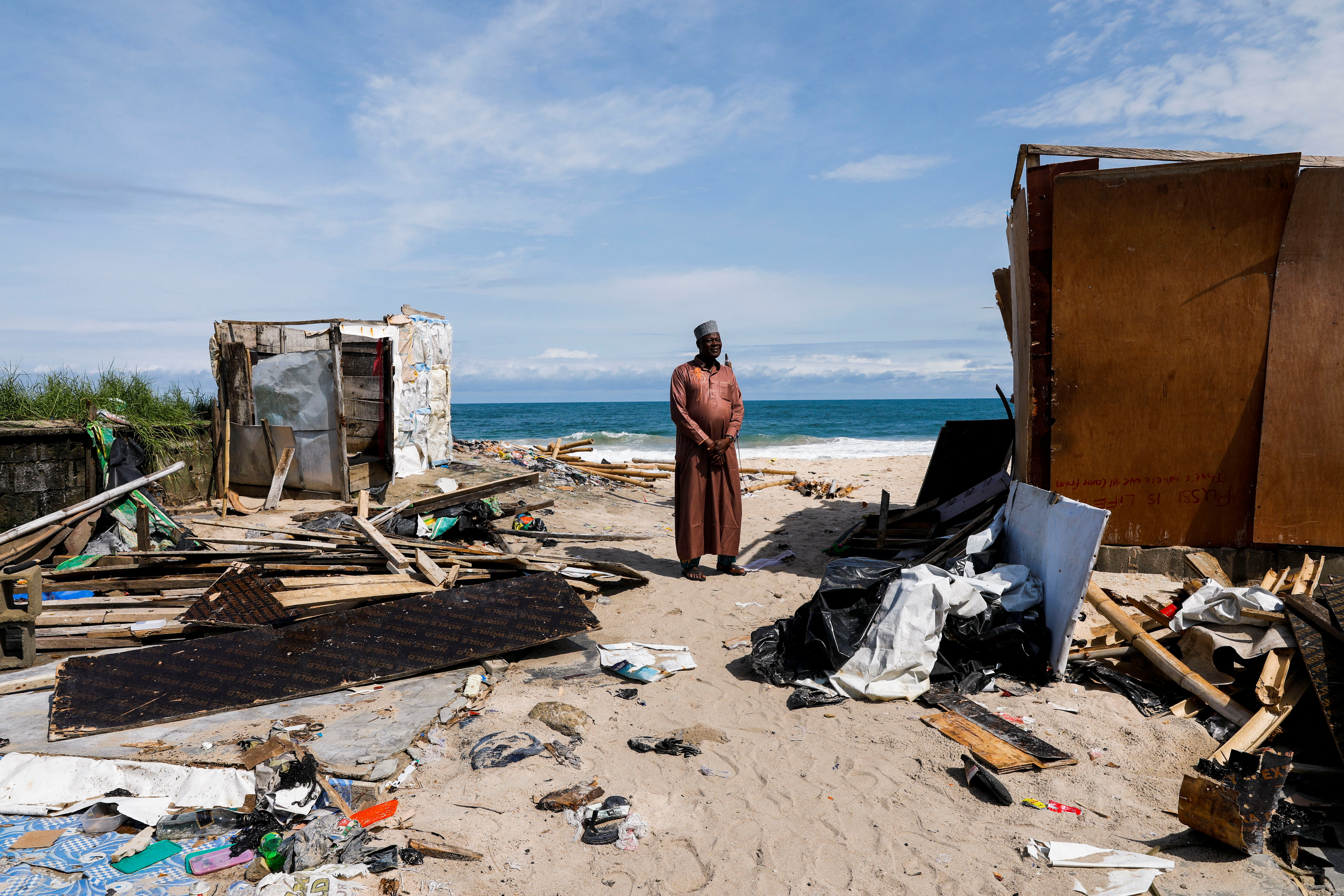 Mureni Alakija, 68, a Nigerian businessman displaced by an ocean surge, stands on the shore of Alpha beach, in Lagos