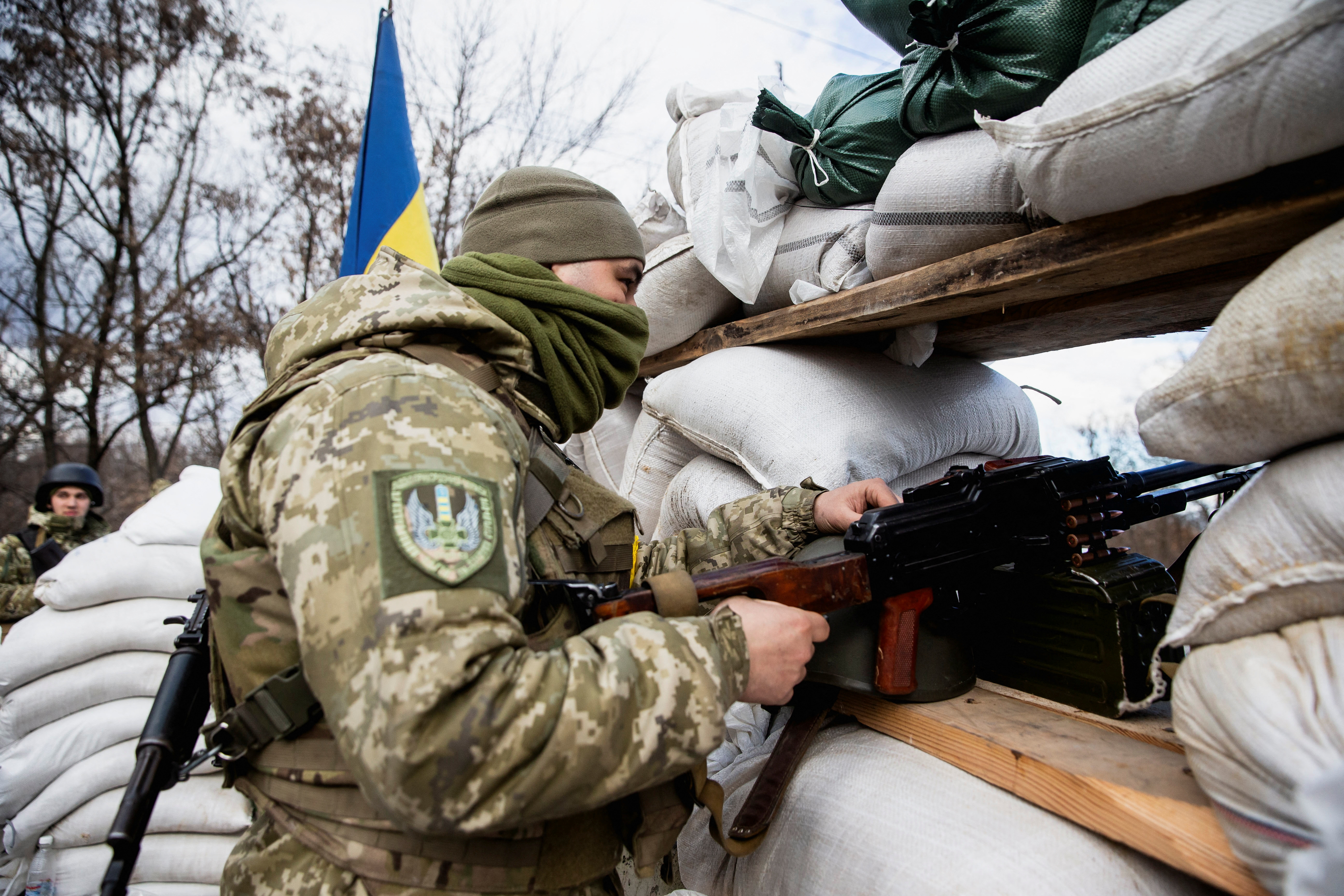 A Ukrainian service member is seen at a check point in Zhytomyr