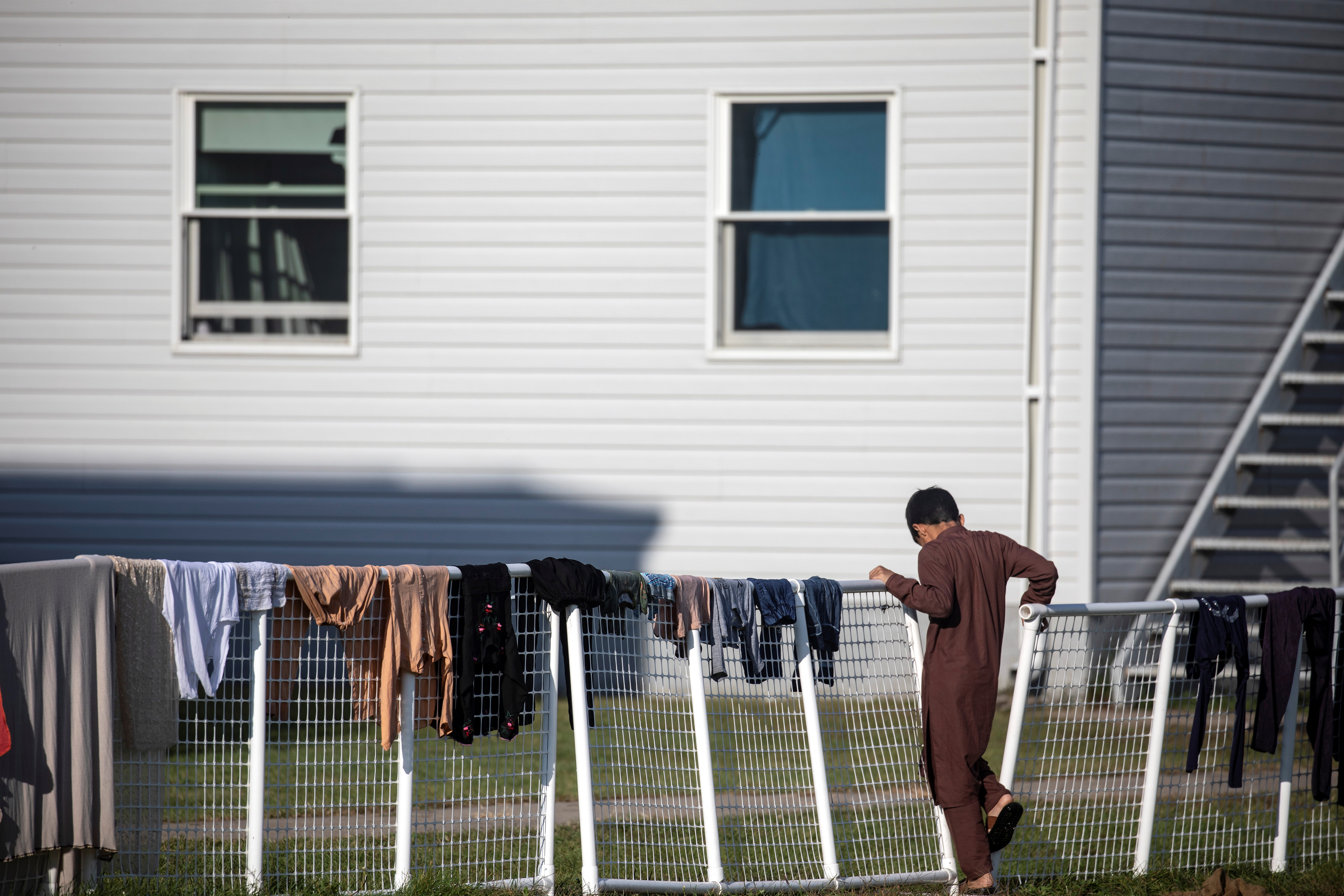 An Afghan refugee stands outside temporary housing at Fort McCoy U.S. Army base, in Wisconsin, U.S., September 30, 2021. Barbara Davidson/Pool via REUTERS