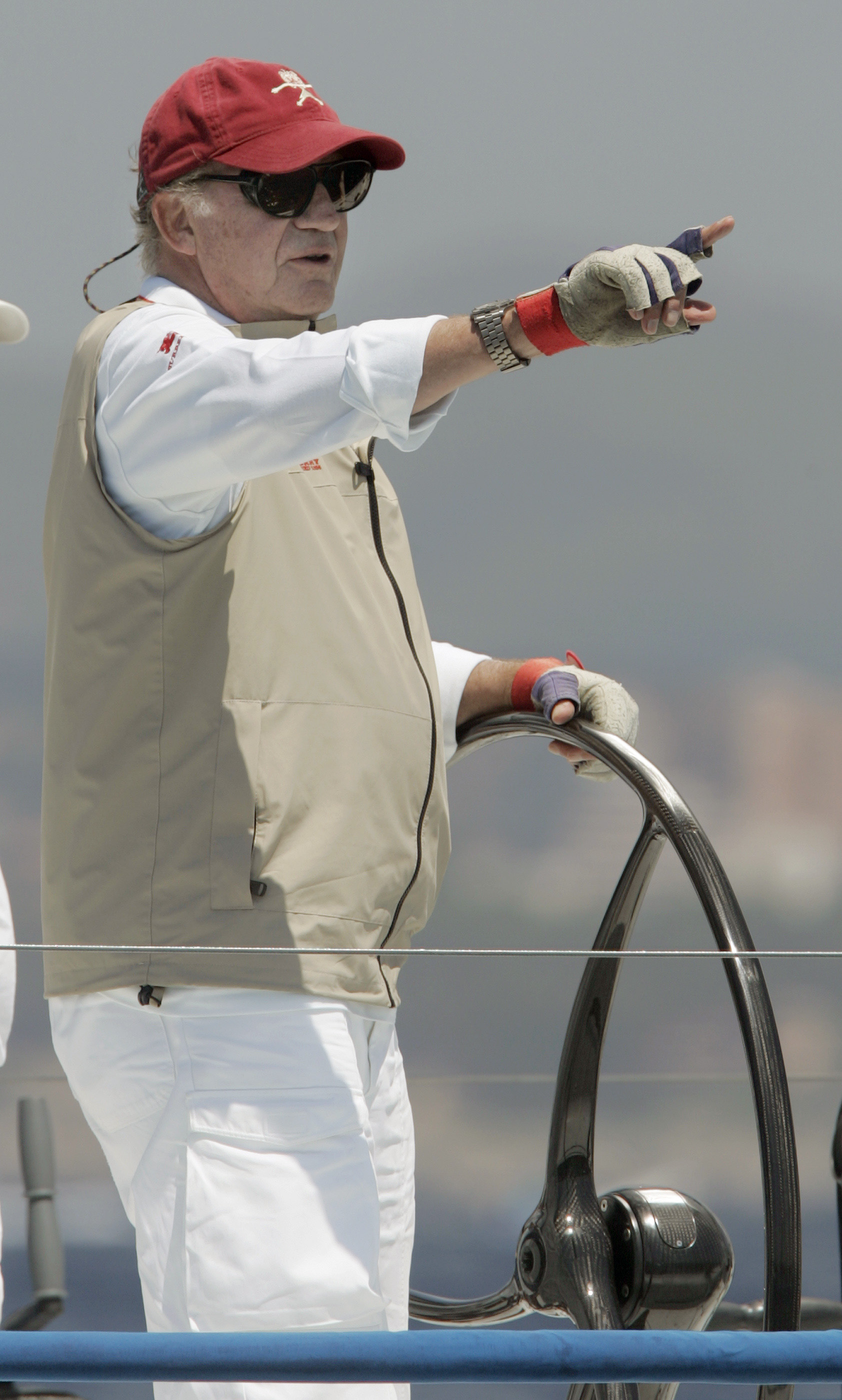 Spanish King Juan Carlos gestures aboard the yacht 