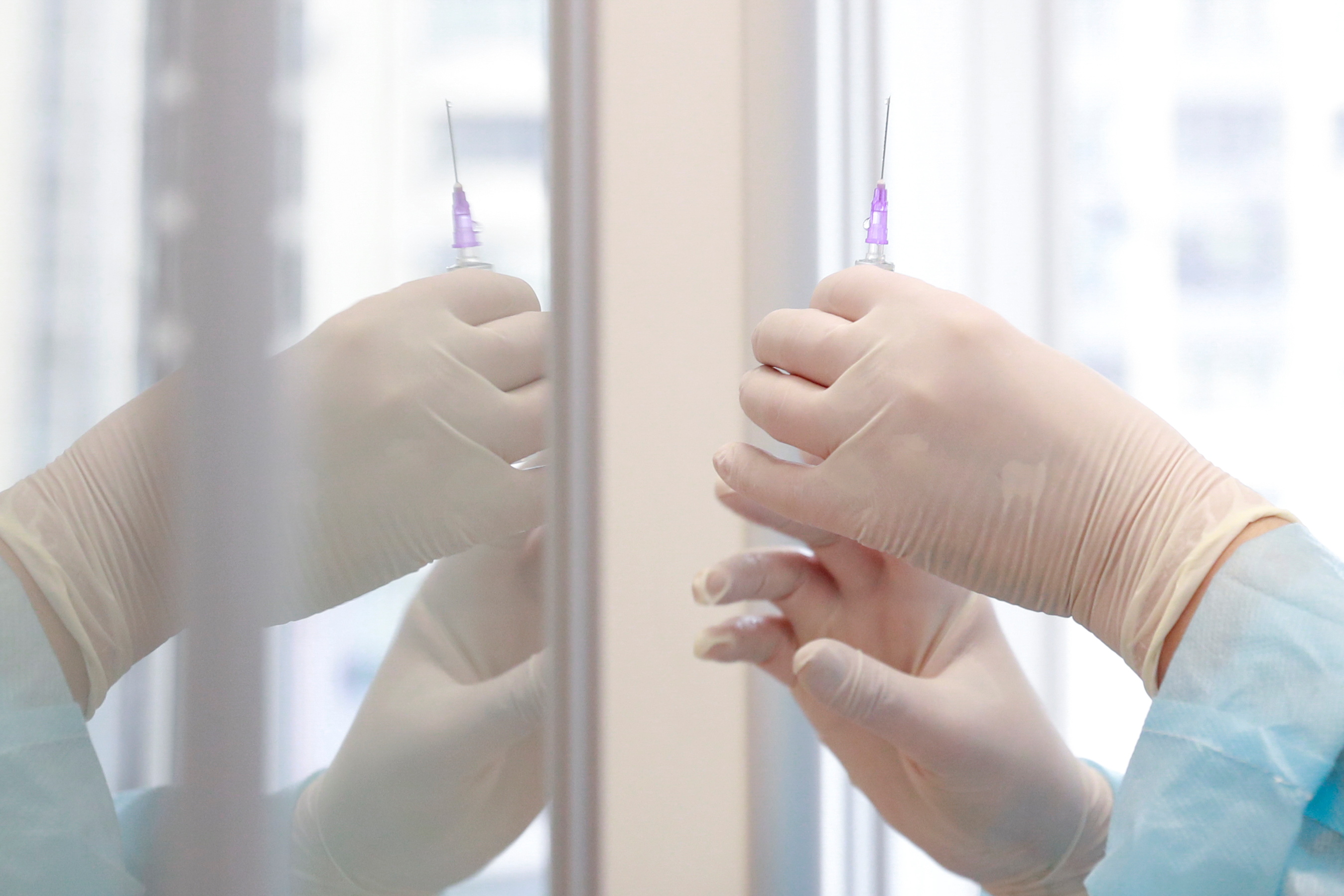 A medical worker holds a syringe with COVID-19 vaccine at a hospital in Kyiv