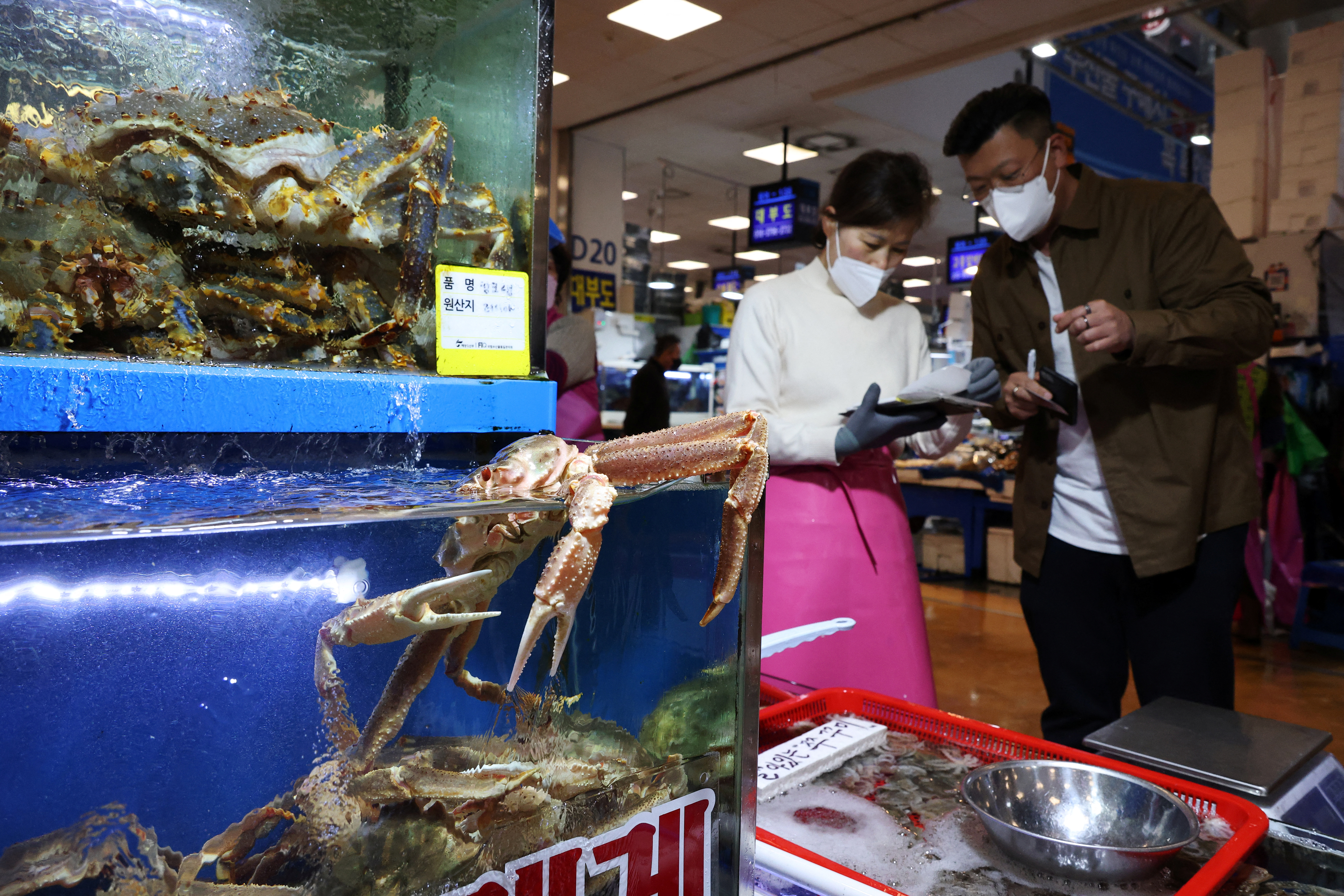 A man shops crabs, imported from Russia, at Noryangjin Fisheries Wholesale Market, in Seoul