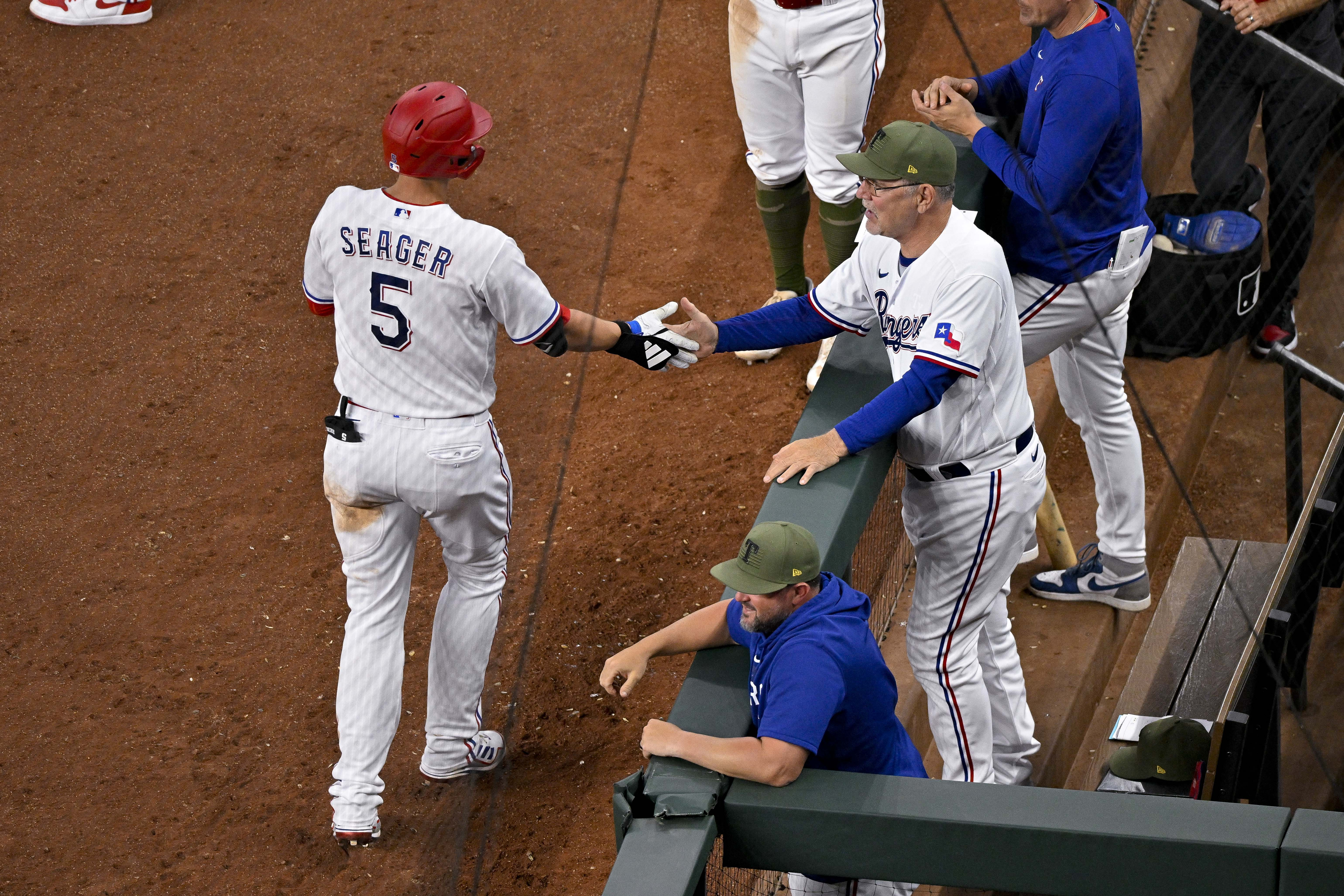 Rangers' offense explodes in 11-5 victory over Rockies