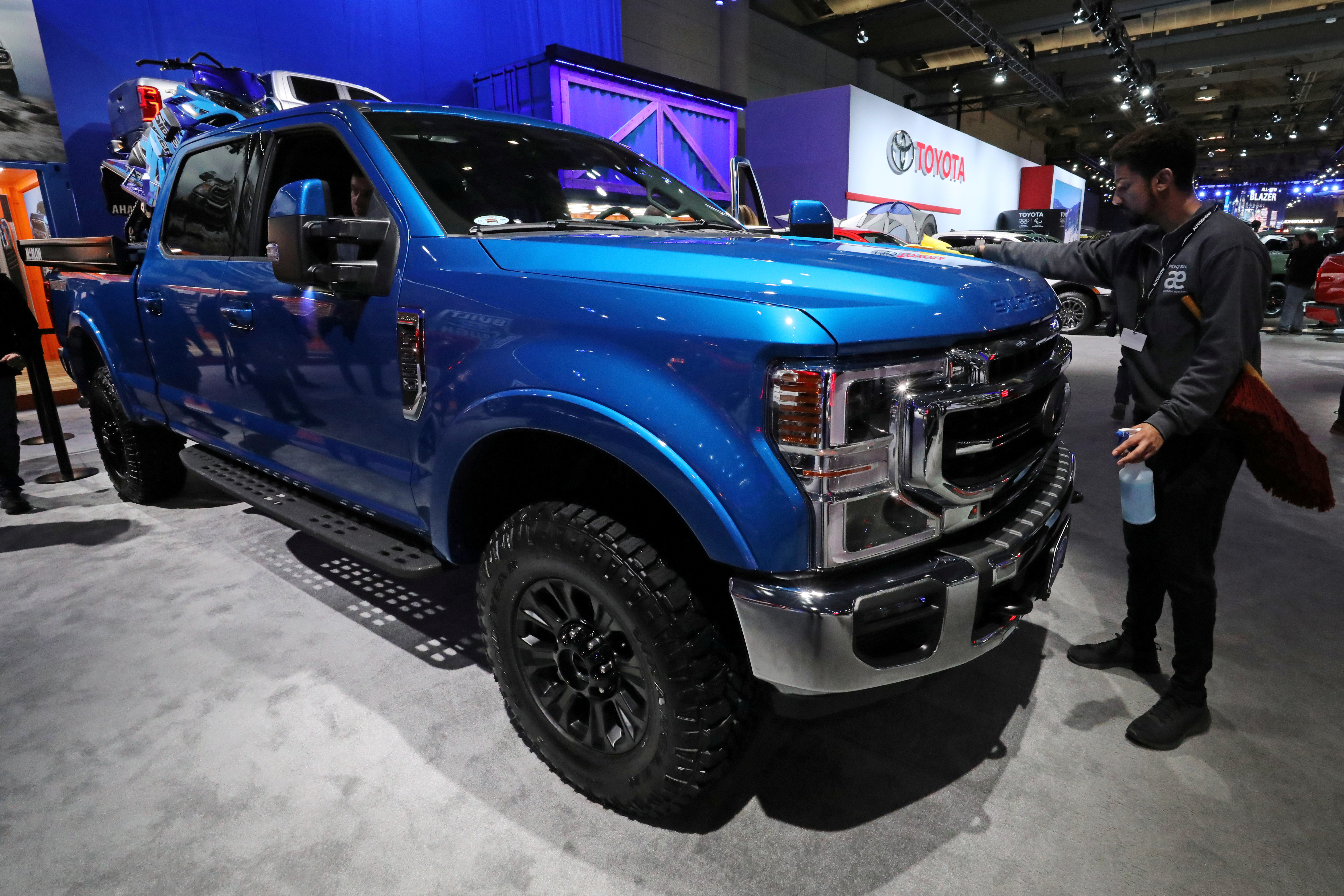 A worker polishes a Ford Super Duty F350 4X4 truck at the Canadian International Auto Show in Toronto
