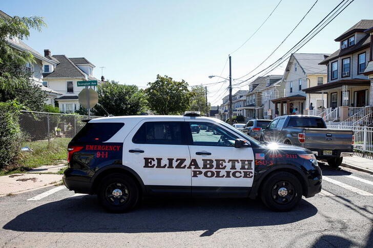 An Elizabeth Police vehicle is parked near the Oakwood Plaza apartments in the aftermath of flooding, in Elizabeth