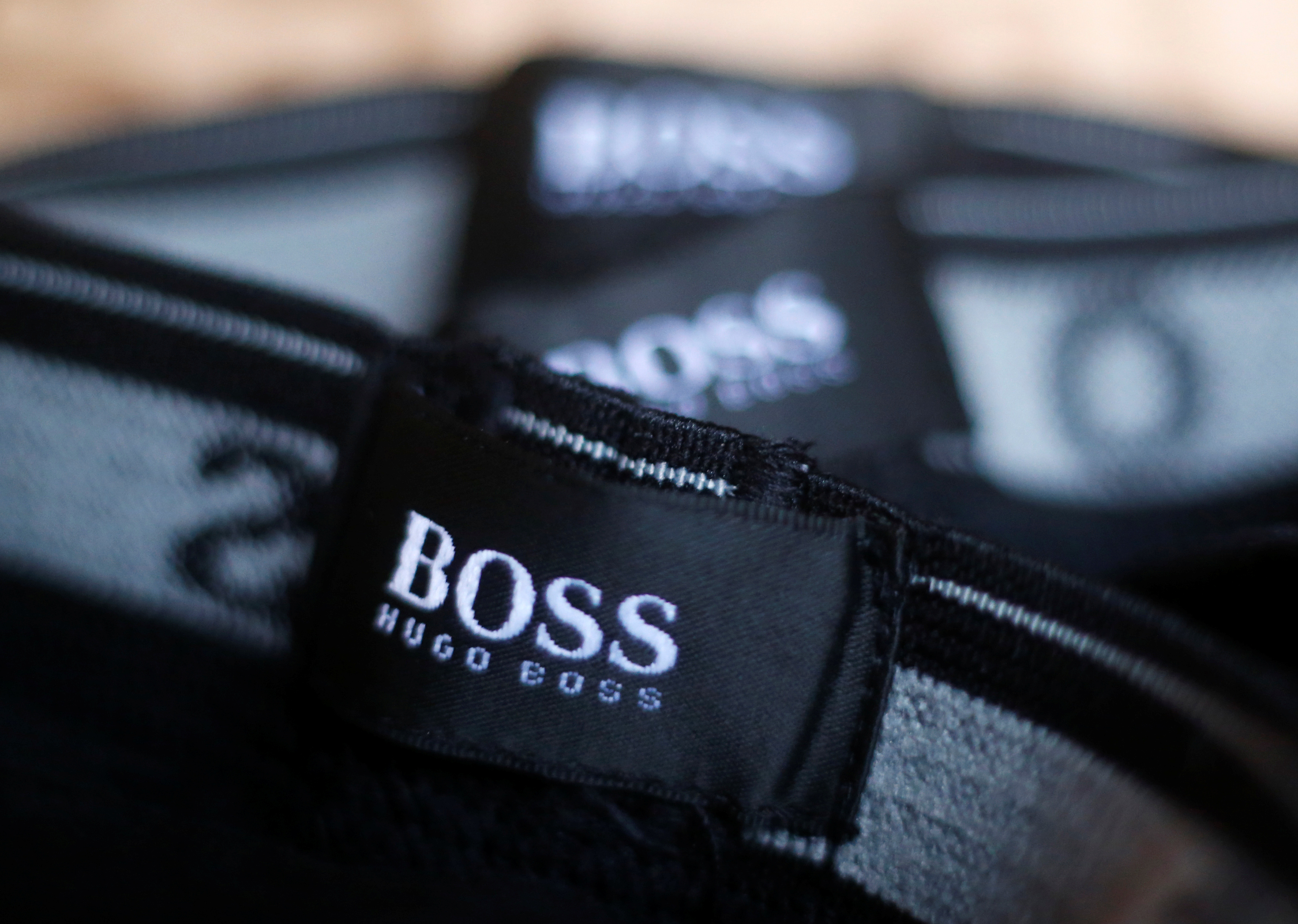 The logo of German fashion house Hugo Boss is seen on a clothing label at their outlet store in Mezingen near Stuttgart