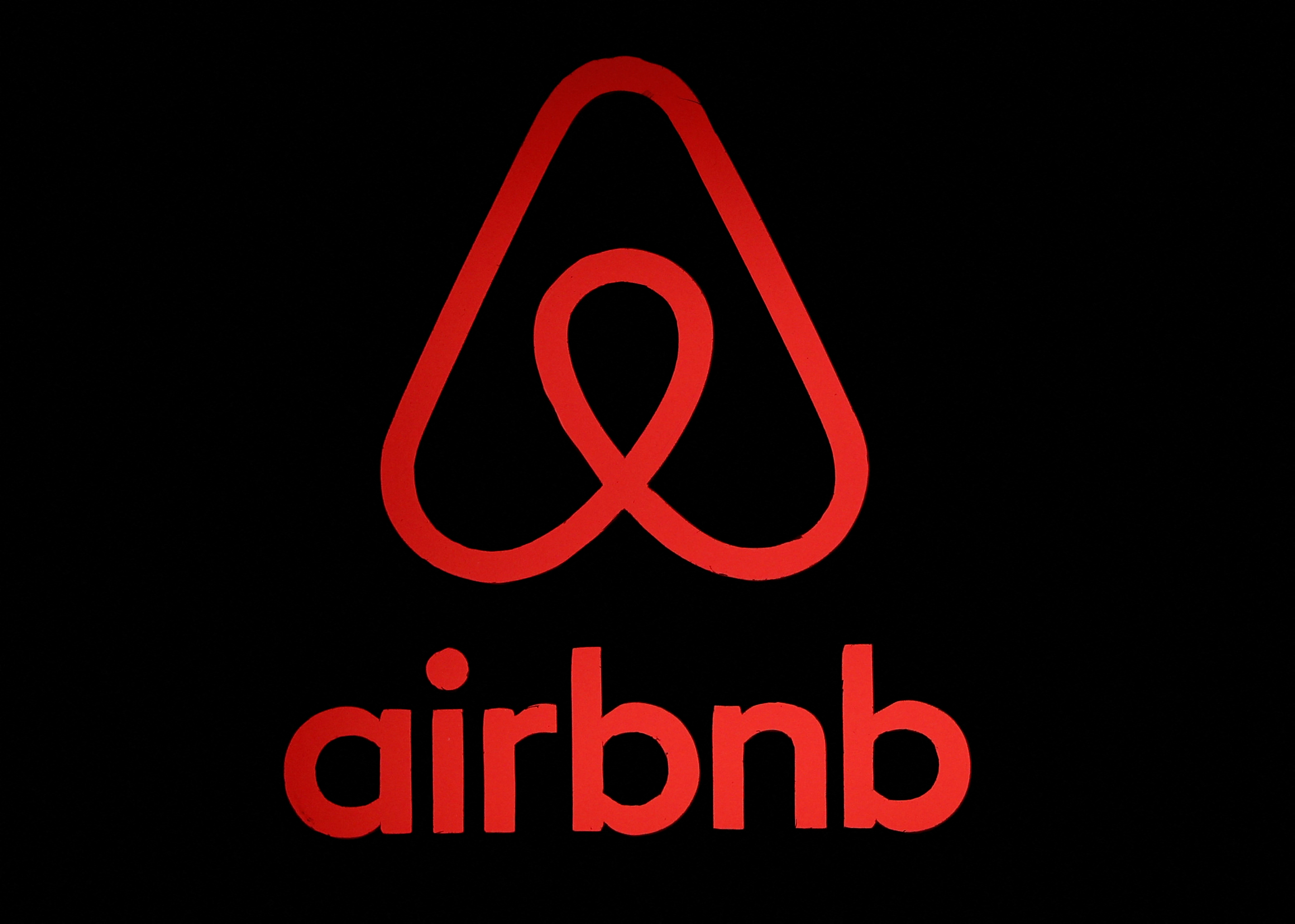 The logo of Airbnb is displayed at an Airbnb event in Tokyo