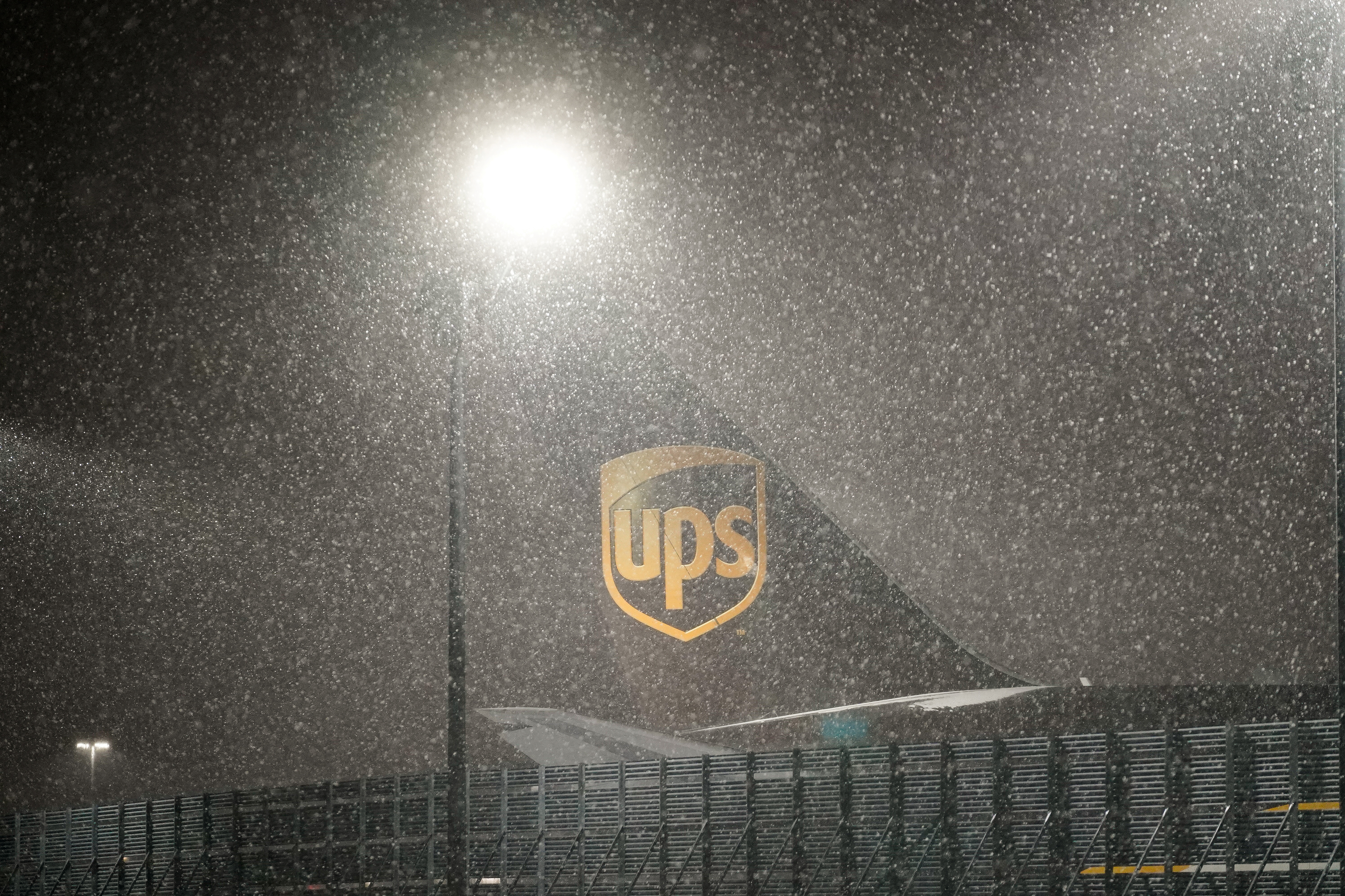 Snow falls at the United Parcel Service (UPS) WorldPort hub located at Louisville Muhammad Ali International Airport in Louisville