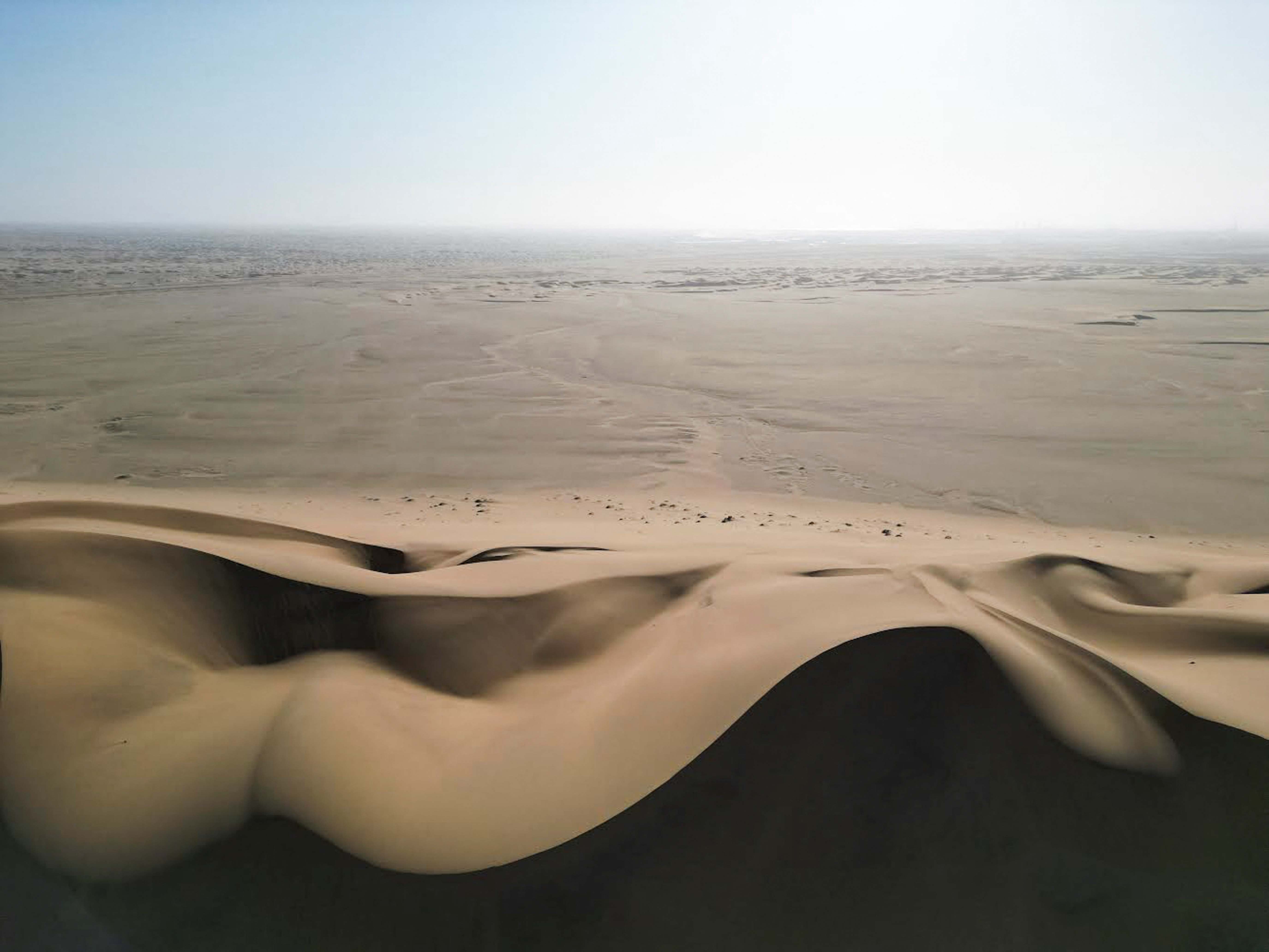 A drone view of Dune 7 and a desert in the background in Walvis Bay