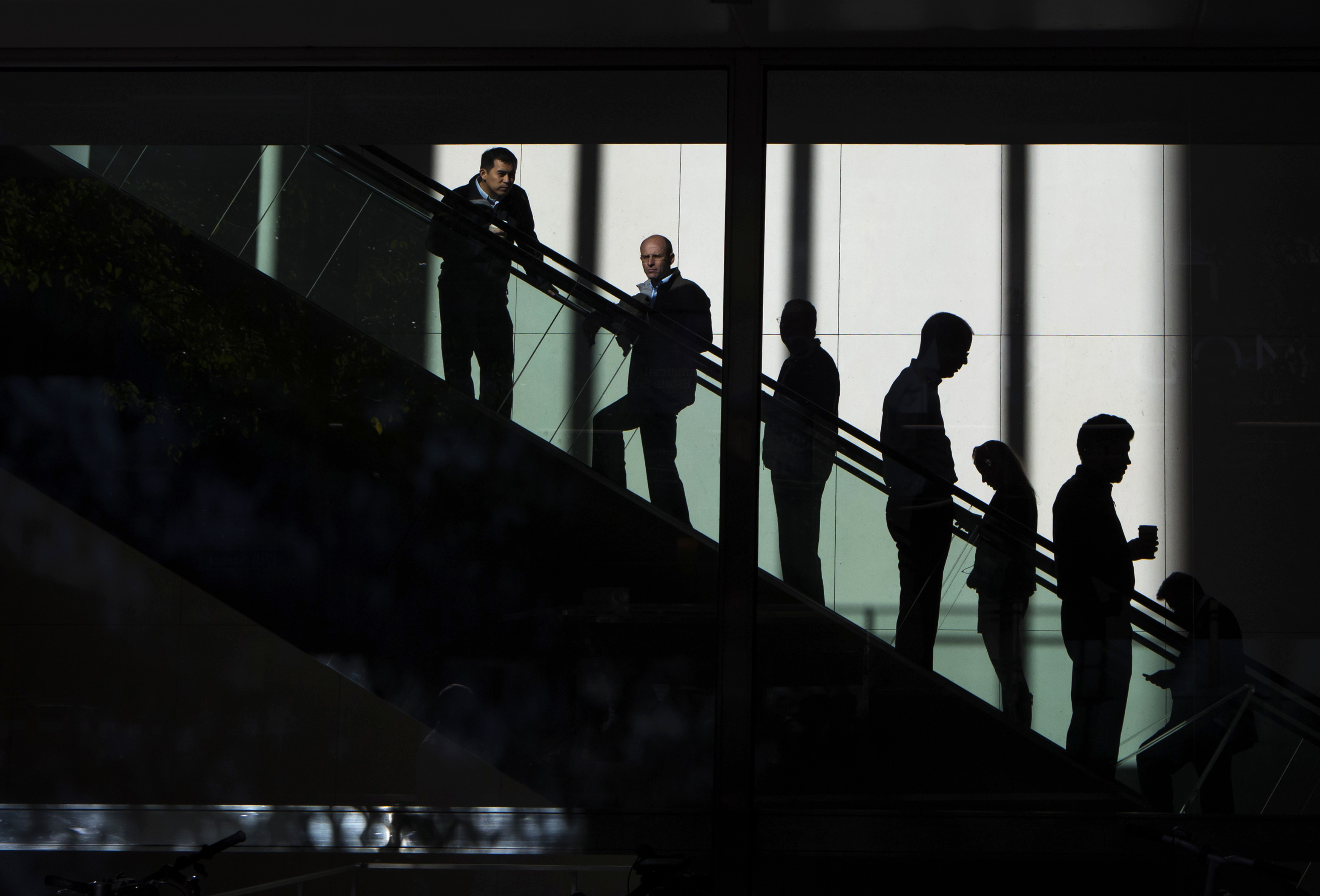 People ride the escalators in the JP Morgan & Chase Co. building in New York October 24, 2013.