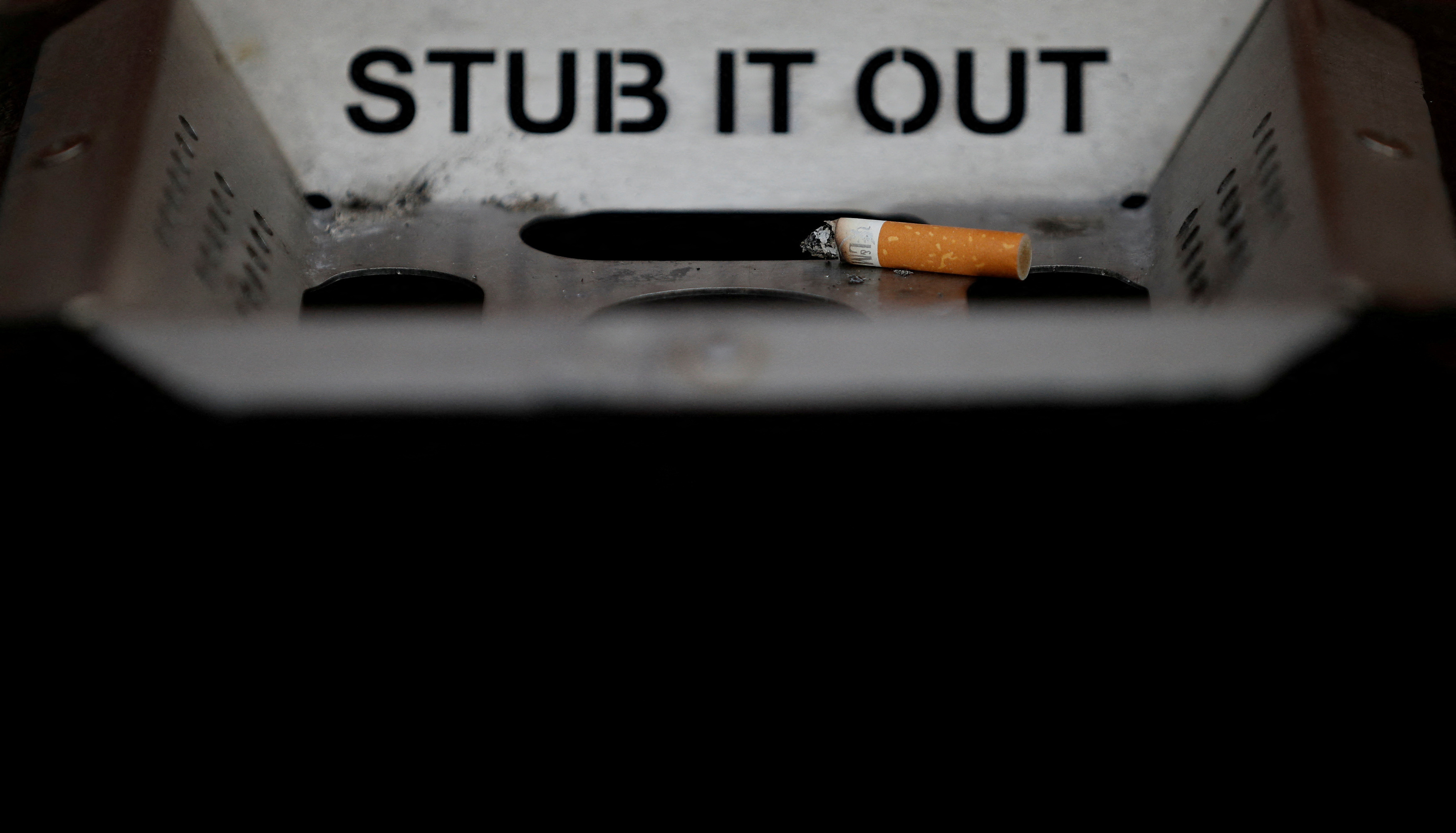 A cigarette stub is seen in an ashtray on a street in Liverpool , northern England