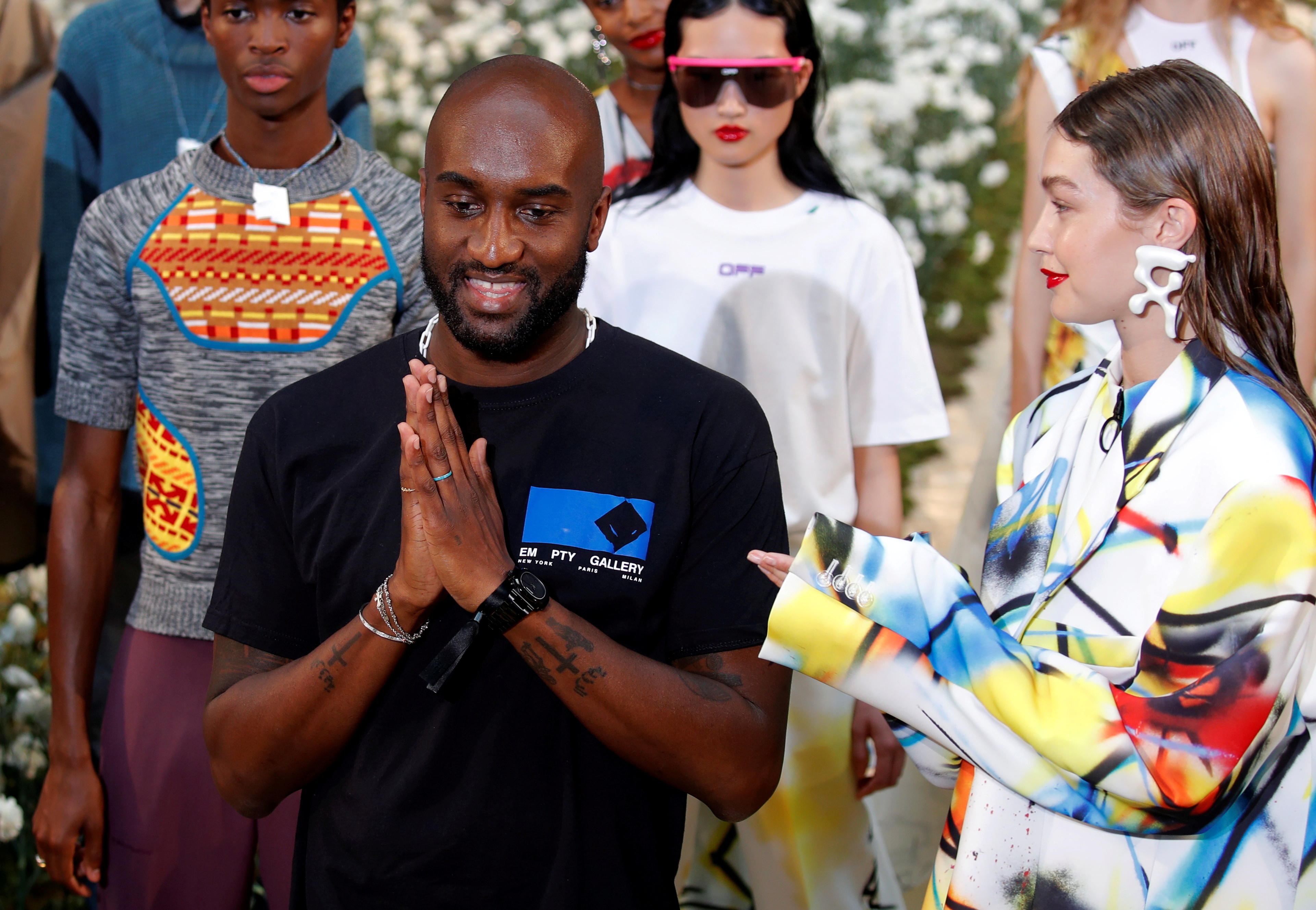 Designer Virgil Abloh appears with model Gigi Hadid at the end of his Spring/Summer 2020 collection show for his label Off-White during Men's Fashion Week in Paris, France, June 19, 2019. REUTERS/Charles Platiau