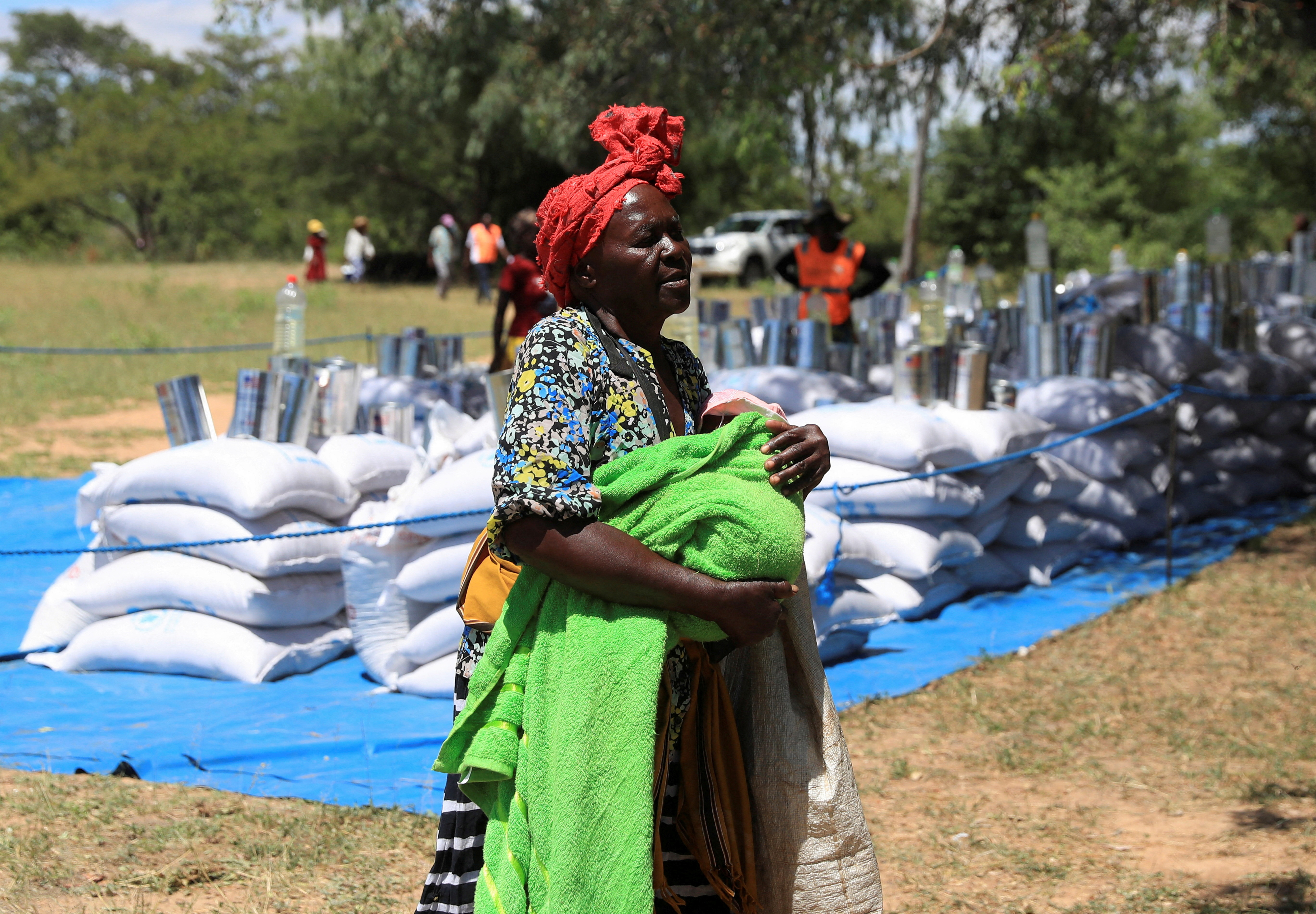 Villagers collect monthly allocations of food aid provided by WFP in Mumijo