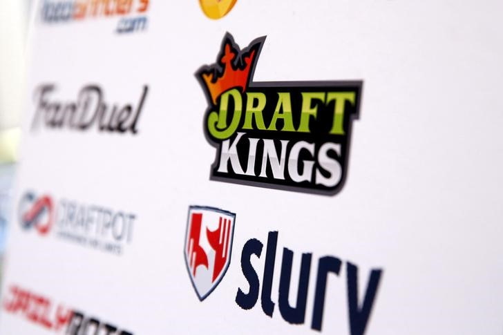 A DraftKings logo is displayed on a board inside of the DFS Players Conference in New York