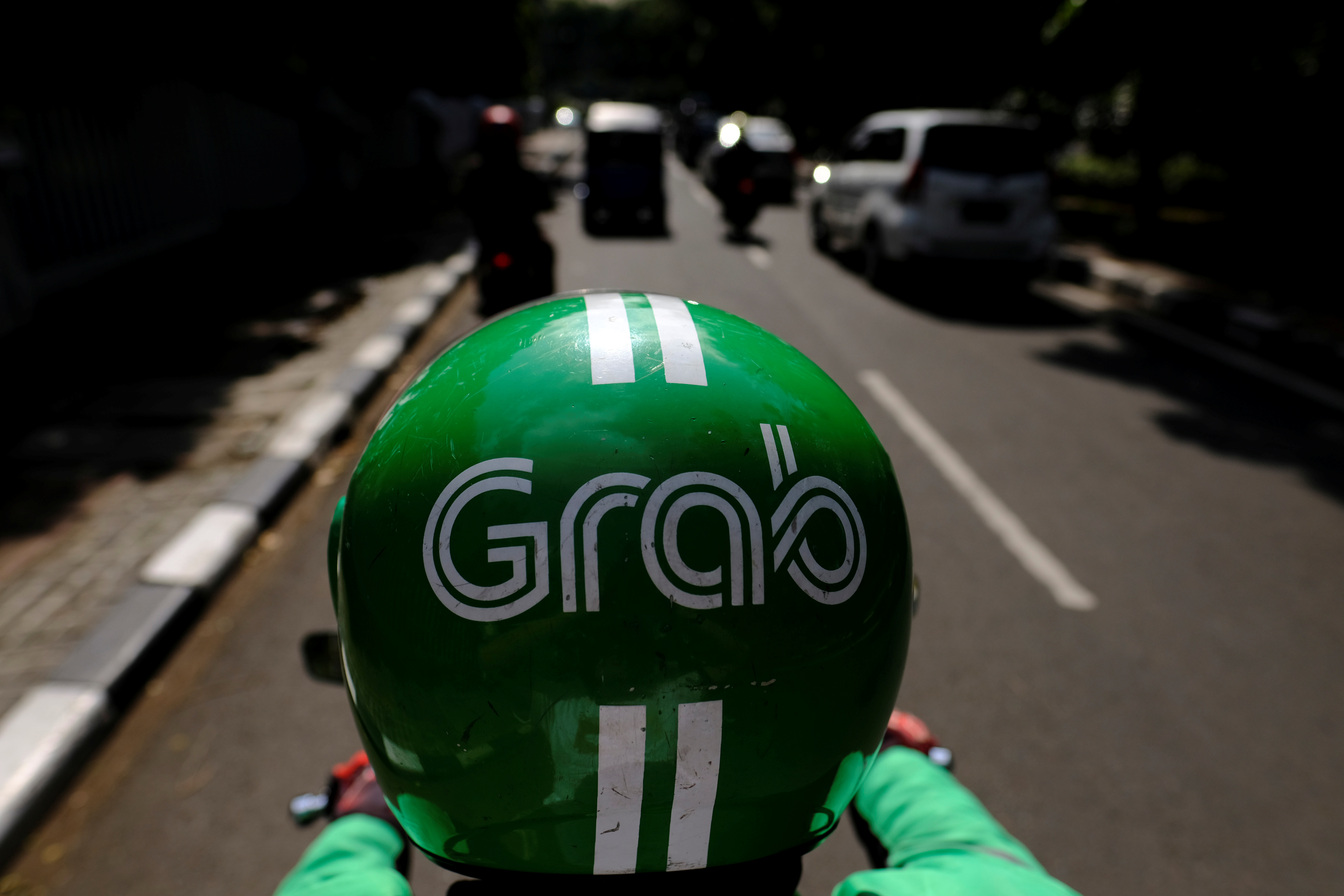 A Grab motor driver is seen in a street in Jakarta