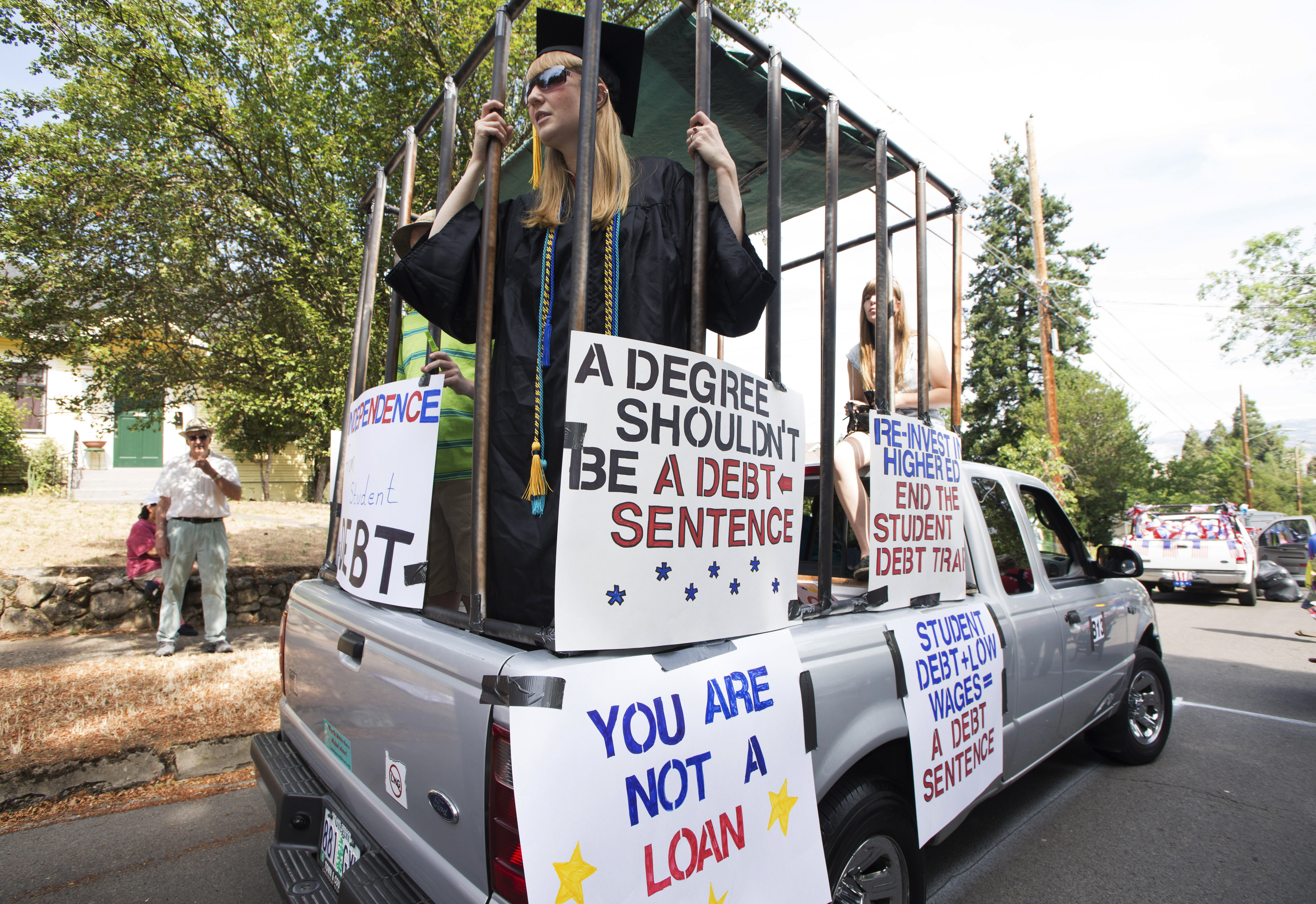 Parade participants protesting against high student loan burdens are preparing to take part in the annual July 4th parade at Ashland