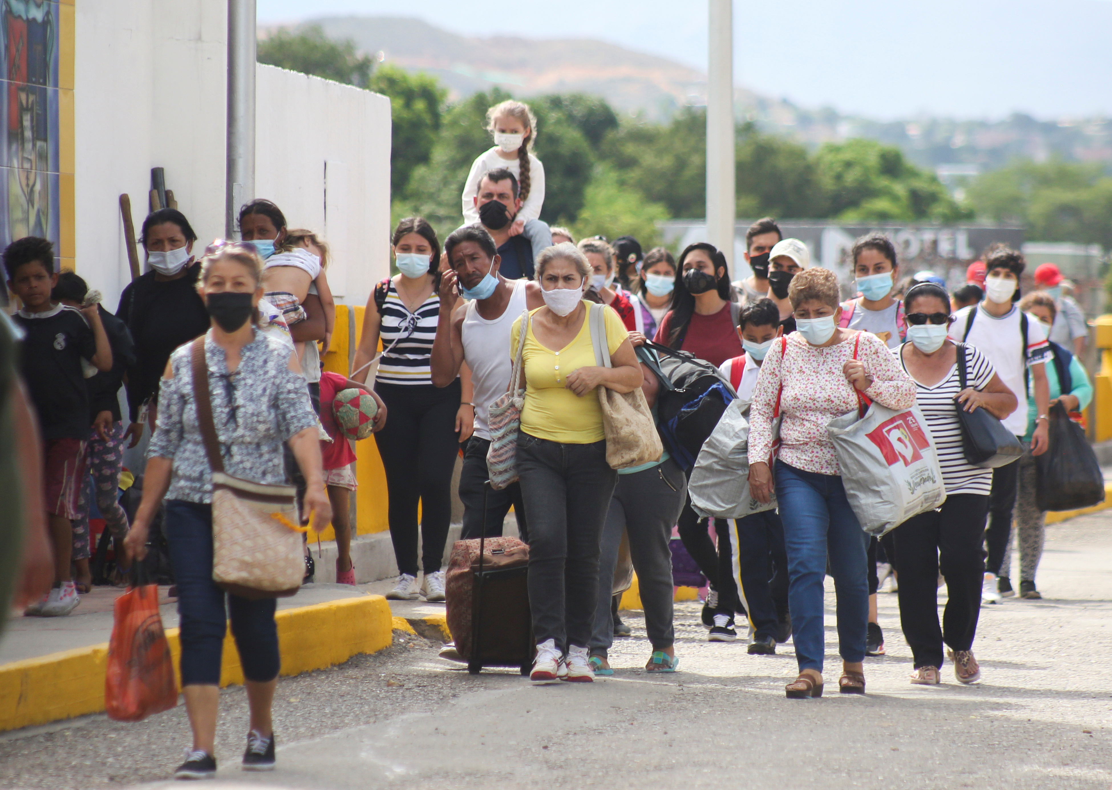 People, permitted for humanitarian reasons, arrive by the Simon Bolivar International bridge from Cucuta, Colombia, as the crossing is reopened in San Antonio del Tachira, Venezuela October 4, 2021. REUTERS/Carlos Eduardo Ramirez