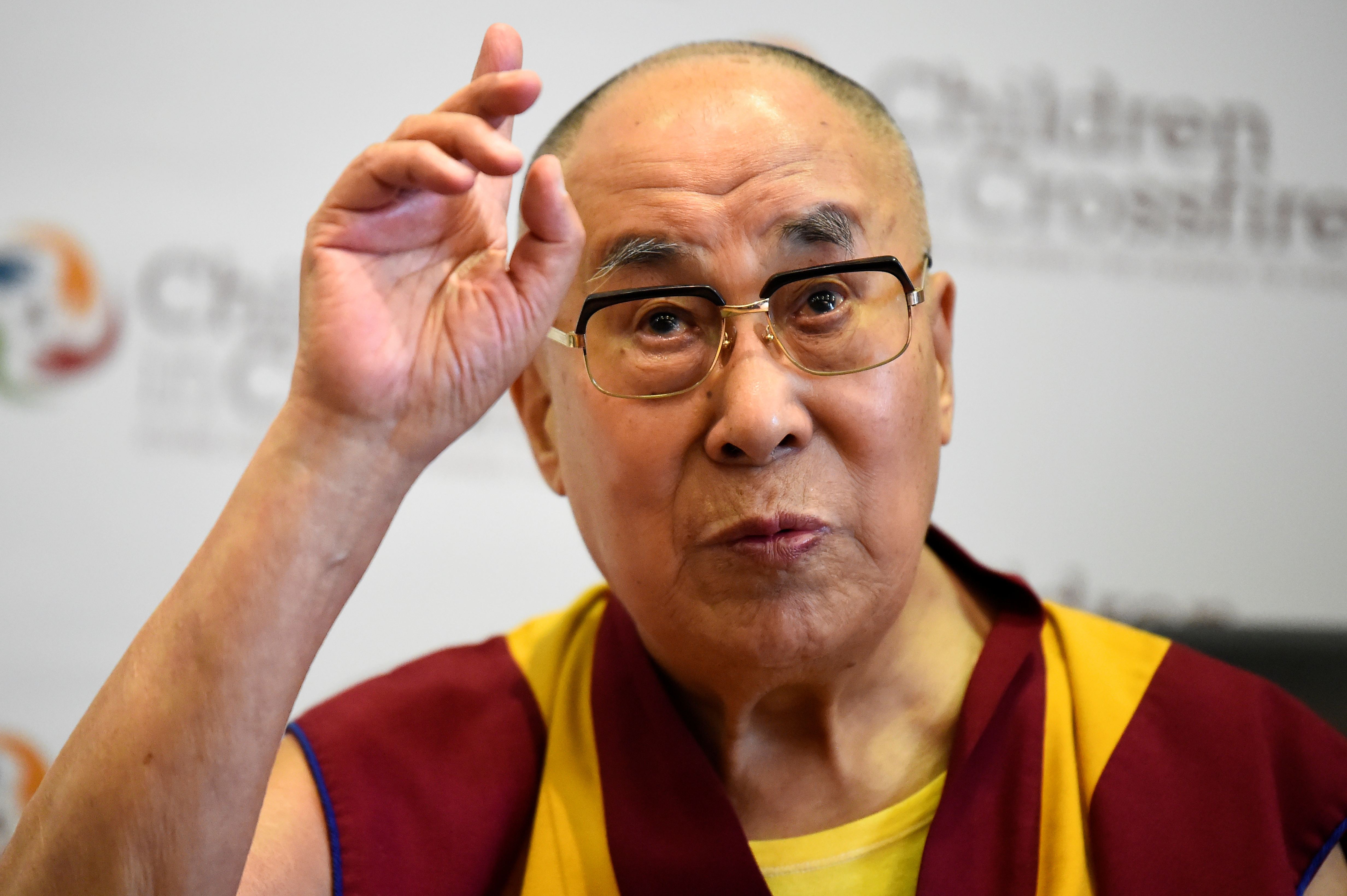 Tibetan spiritual leader the Dalai Lama, Patron of Children in Crossfire, gestures during a press conference in Londonderry