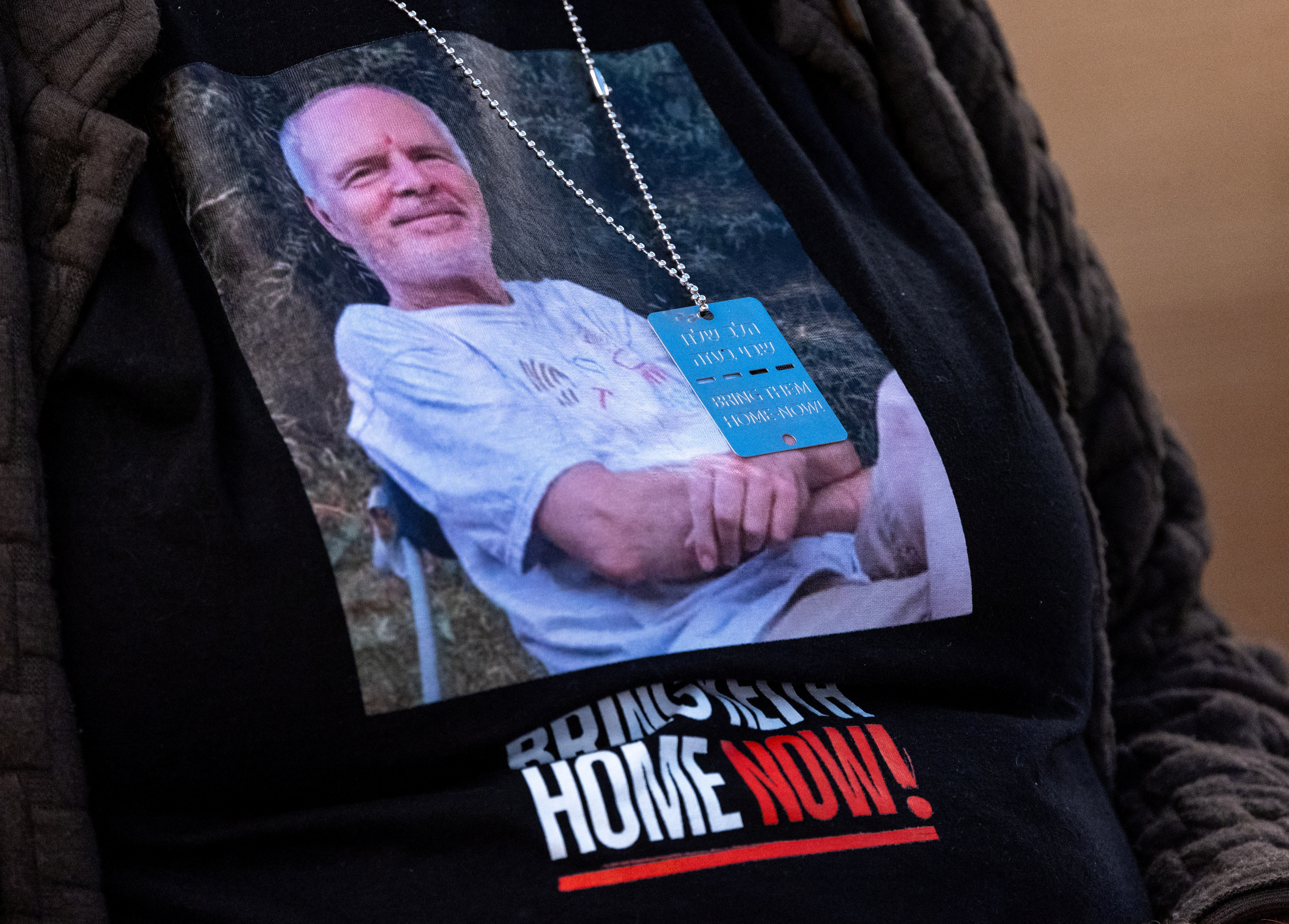 A picture of Hamas hostage Keith Siegel is worn by his wife Aviva at the UN in Geneva