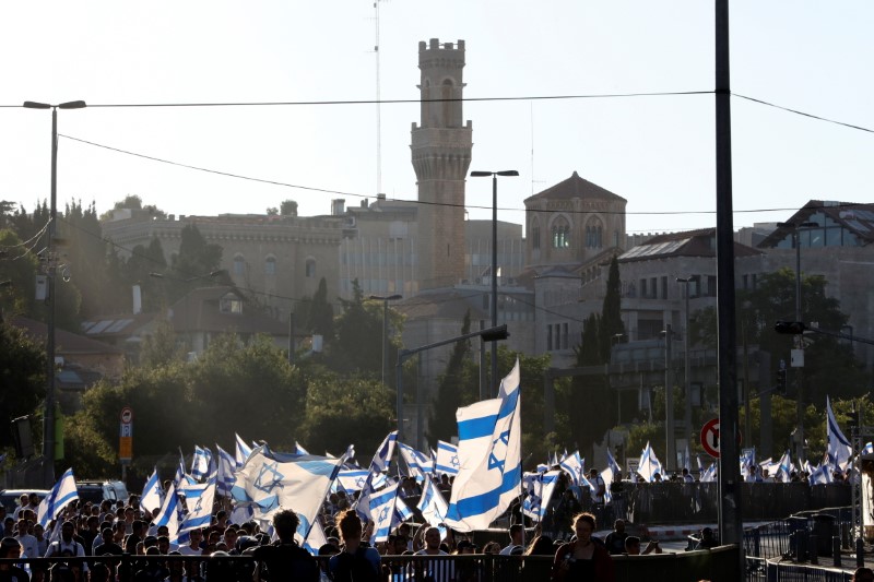 Israelis hold flags outside Jerusalem's Old City, in Jerusalem