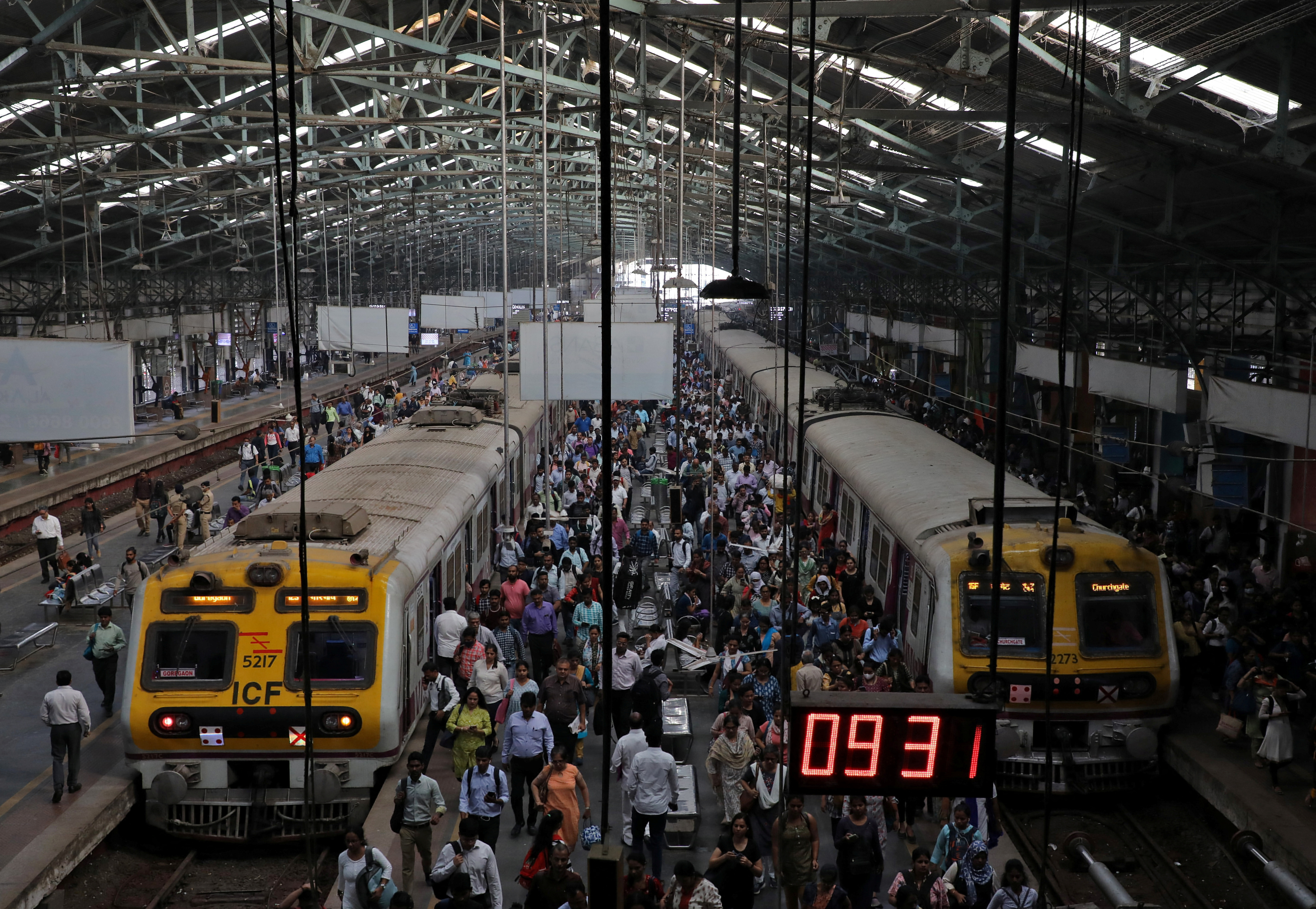 Commuters disembark from suburban trains at Churchgate railway station in Mumbai