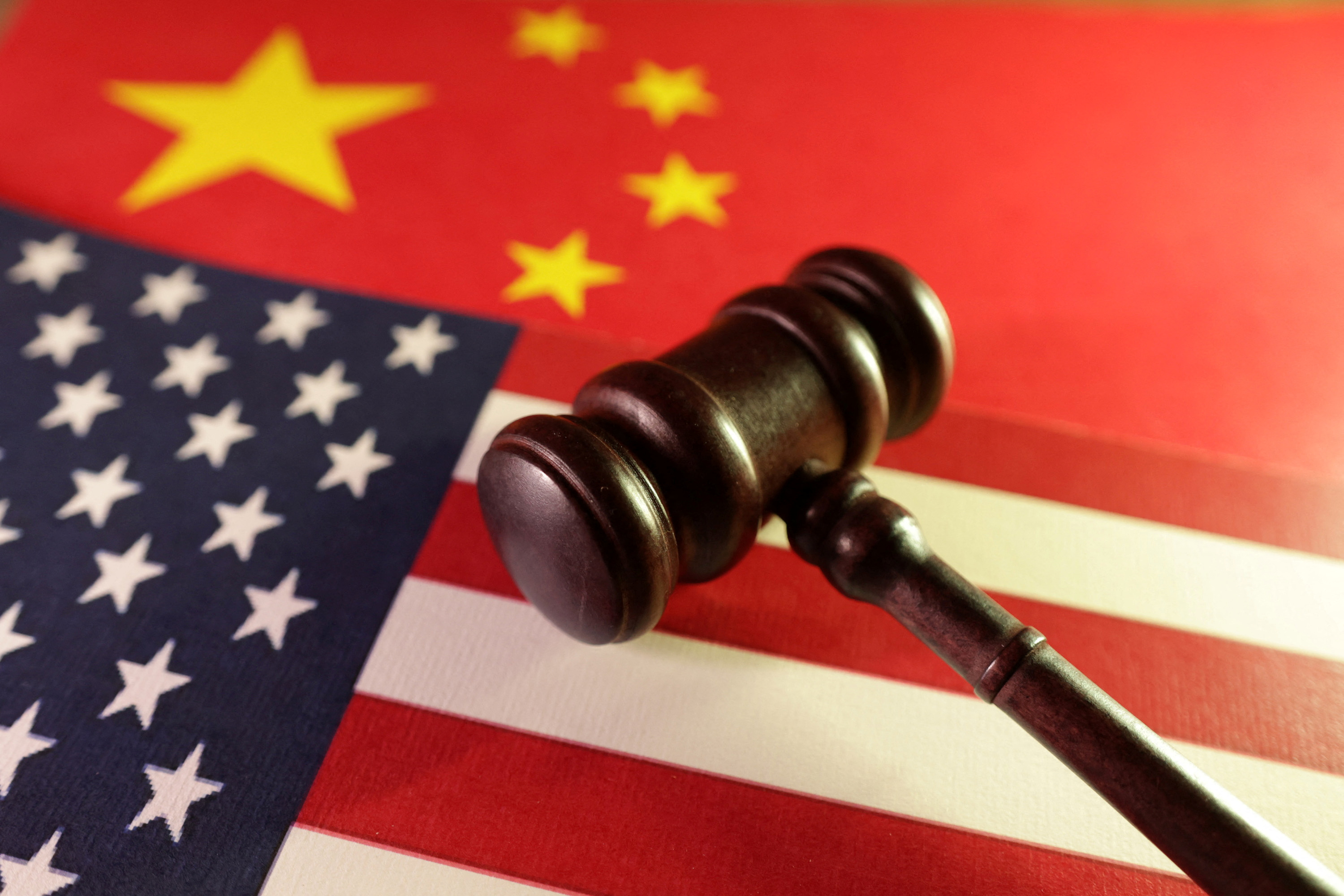 China imposes new curbs on U.S. firms as trade row grows | Reuters