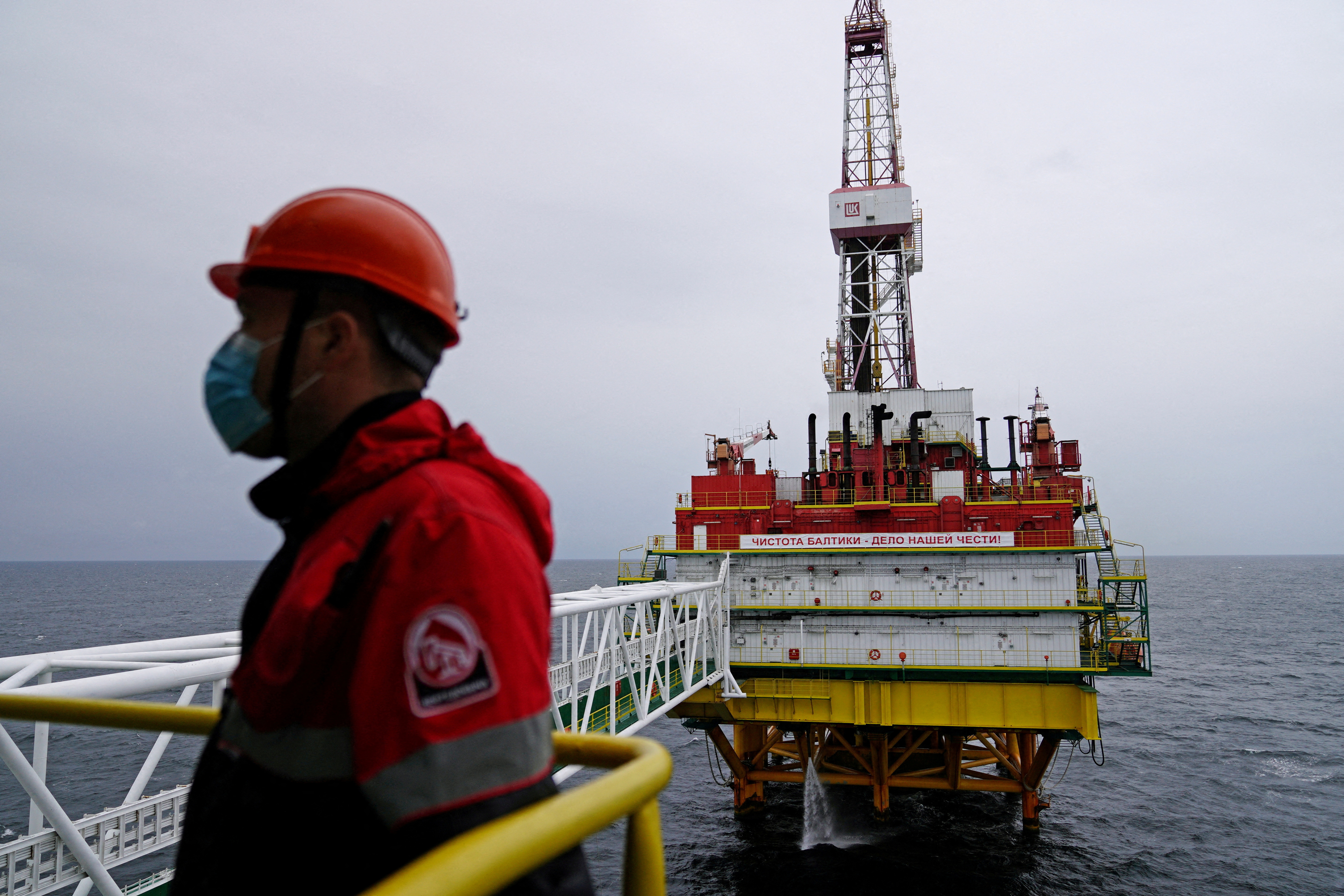 FILE PHOTO: An employee is seen at an oil platform operated by Lukoil company at the Kravtsovskoye oilfield in the Baltic Sea, Russia