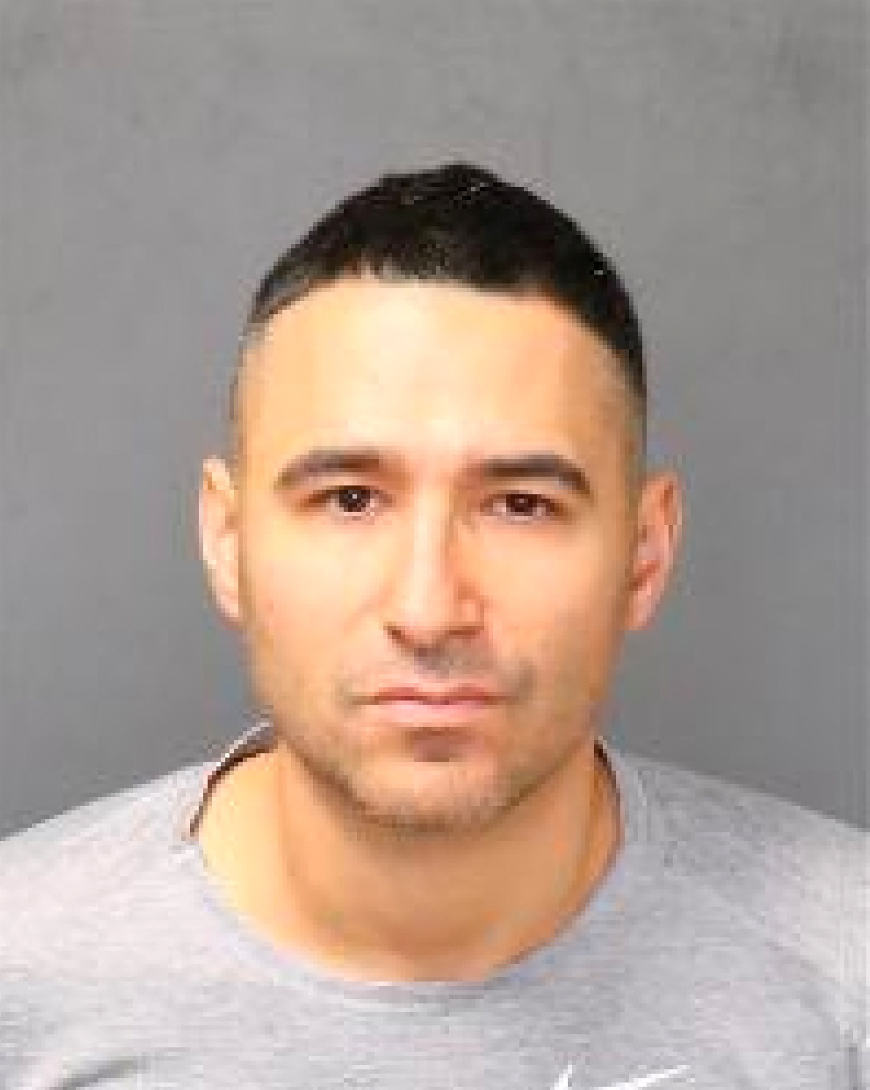 Solomon Pena poses for a jail booking photograph after his arrest by the Albuquerque Police Department
