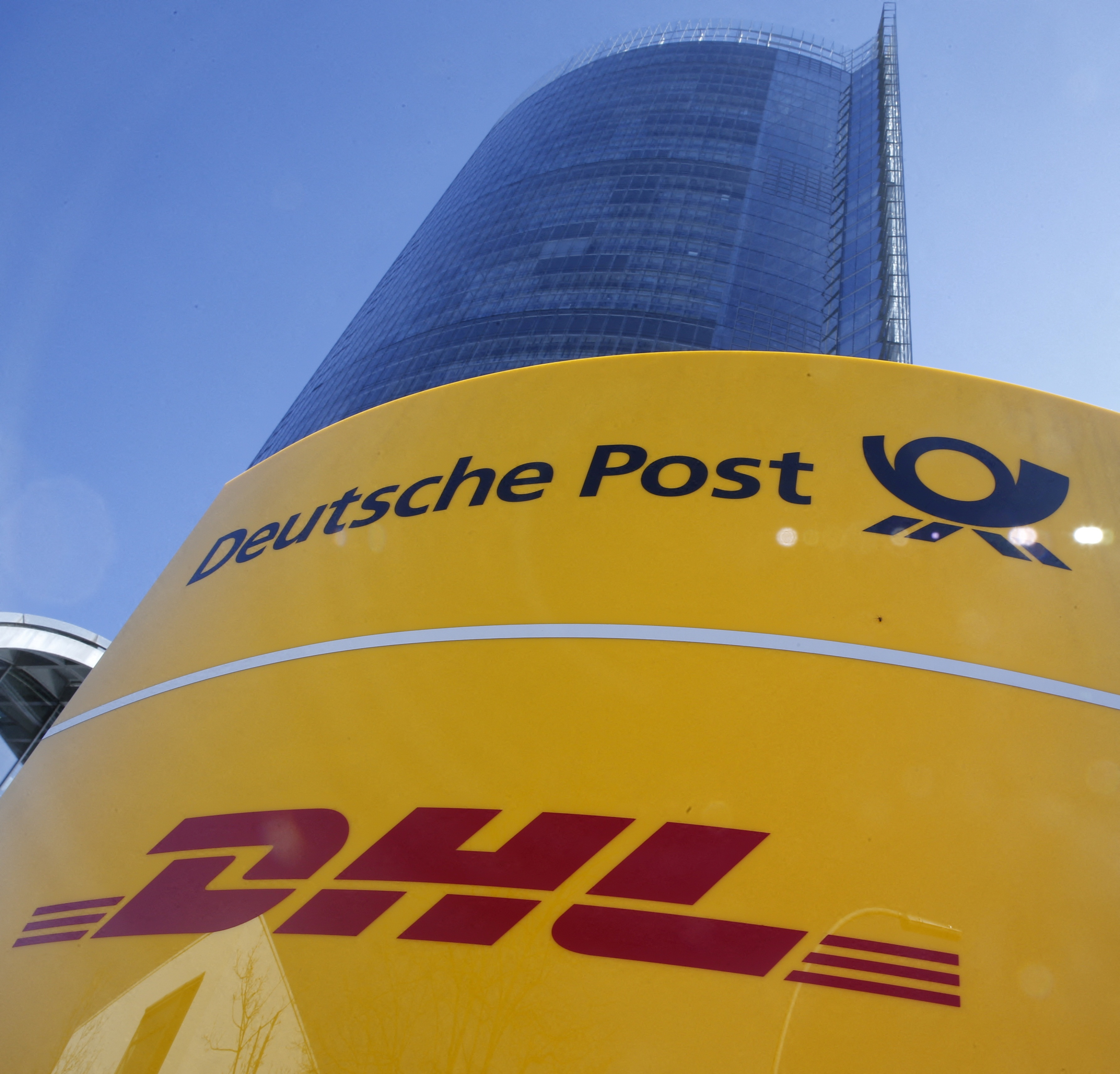 A Deutche Post and DHL sign stands in front of the Bonn Post Tower in Bonn