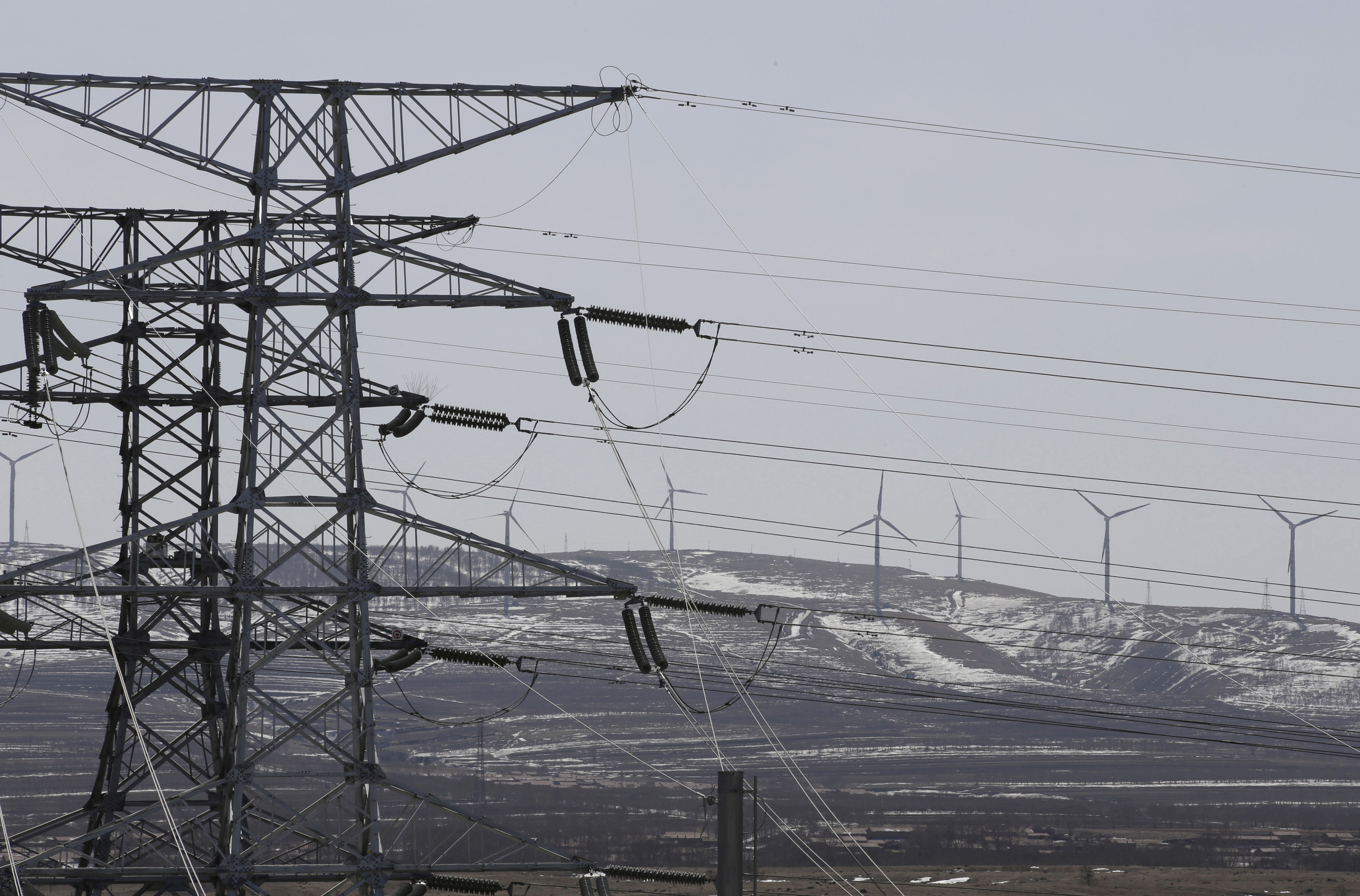 Power lines and wind turbines are pictured at a wind and solar energy storage and transmission power station of State Grid Corporation of China, in Zhangjiakou of Hebei province, China, March 18, 2016. REUTERS/Jason Lee/File Photo/File Photo