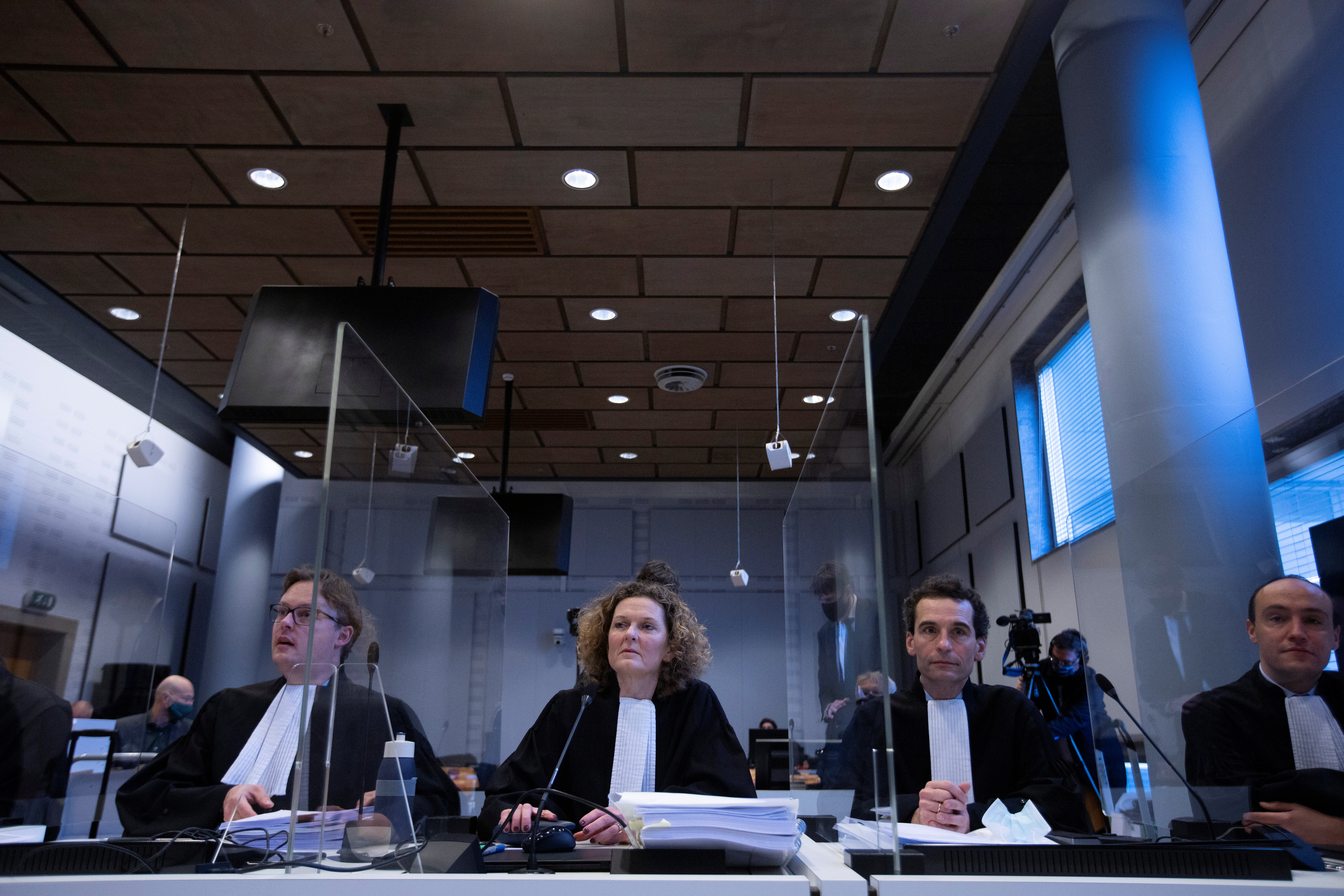 Lawyers for Shell take their seats at the start of the court case environmentalist and human rights groups have brought on against Royal Dutch Shell to force the energy firm to cut its reliance on fossil fuels, in The Hague, Netherlands December 1, 2020. Peter Dejong/Pool via REUTERS