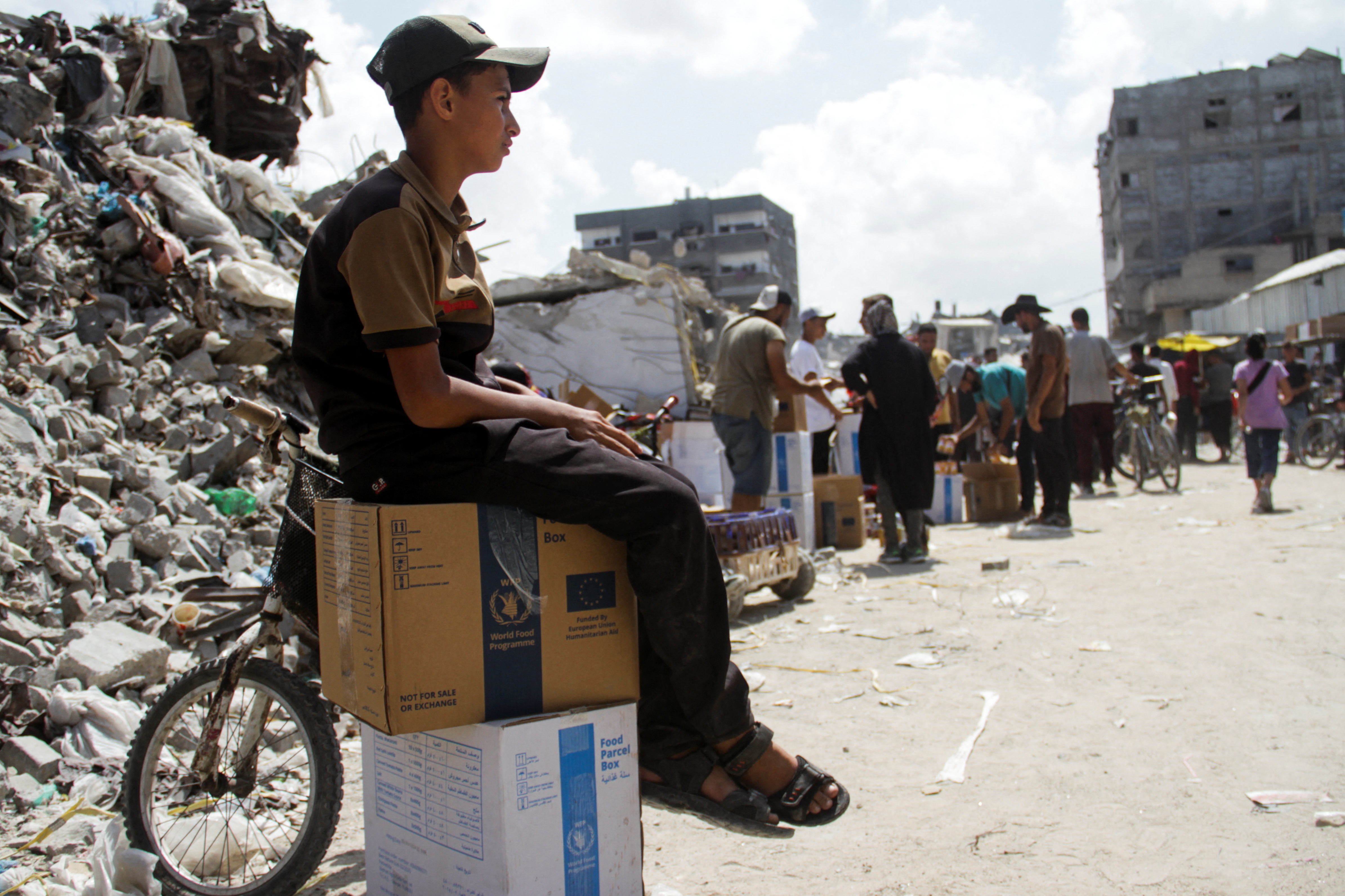 Palestinians gather to receive aid, in Jabalia, northern Gaza Strip