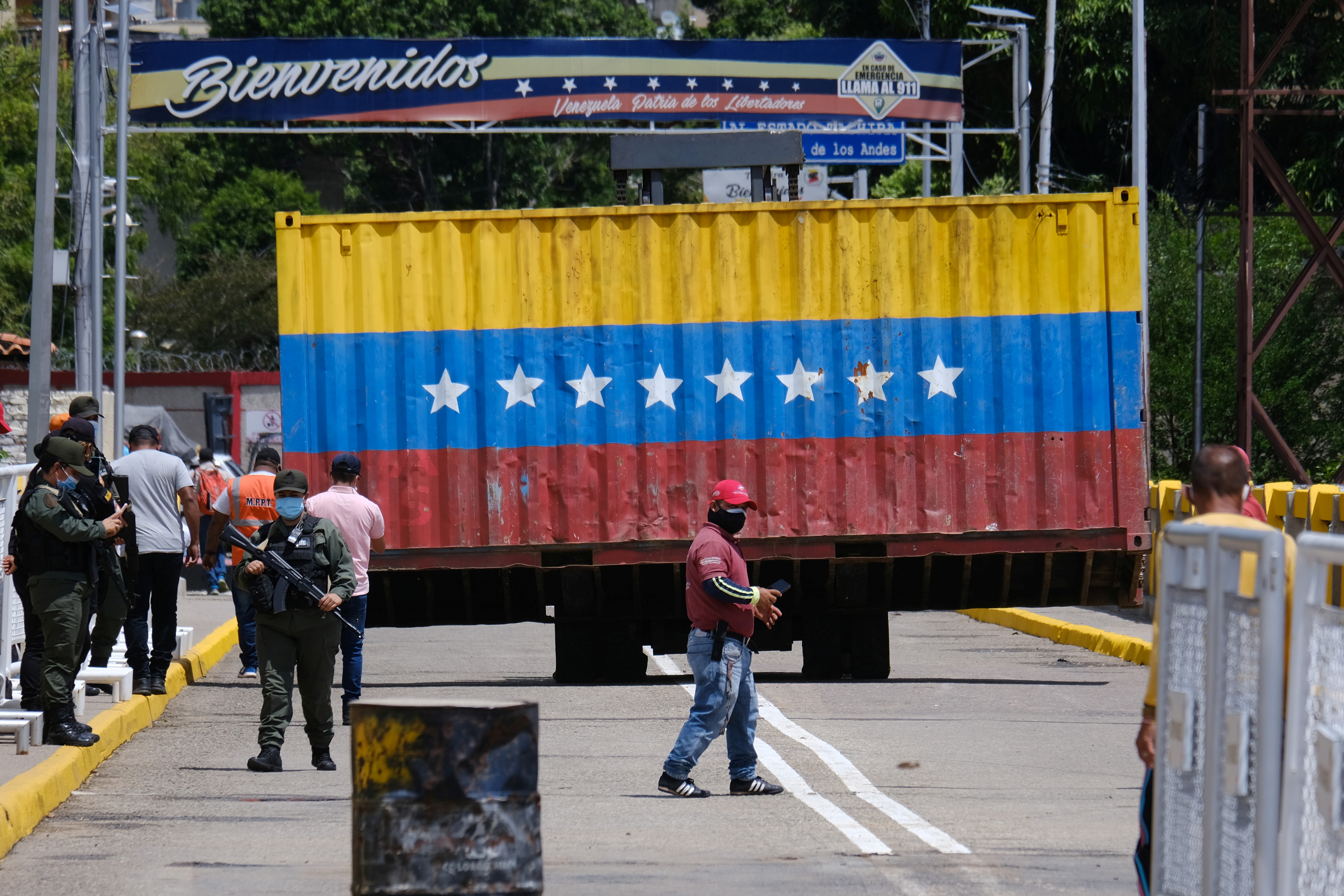 A container that blocked passage on the Simon Bolivar bridge between Cucuta, Colombia and San Antonio del Tachira, Venezuela is removed before the crossing is reopened, as seen from Cucuta, Colombia October 4, 2021. REUTERS/Ferley Ospina 