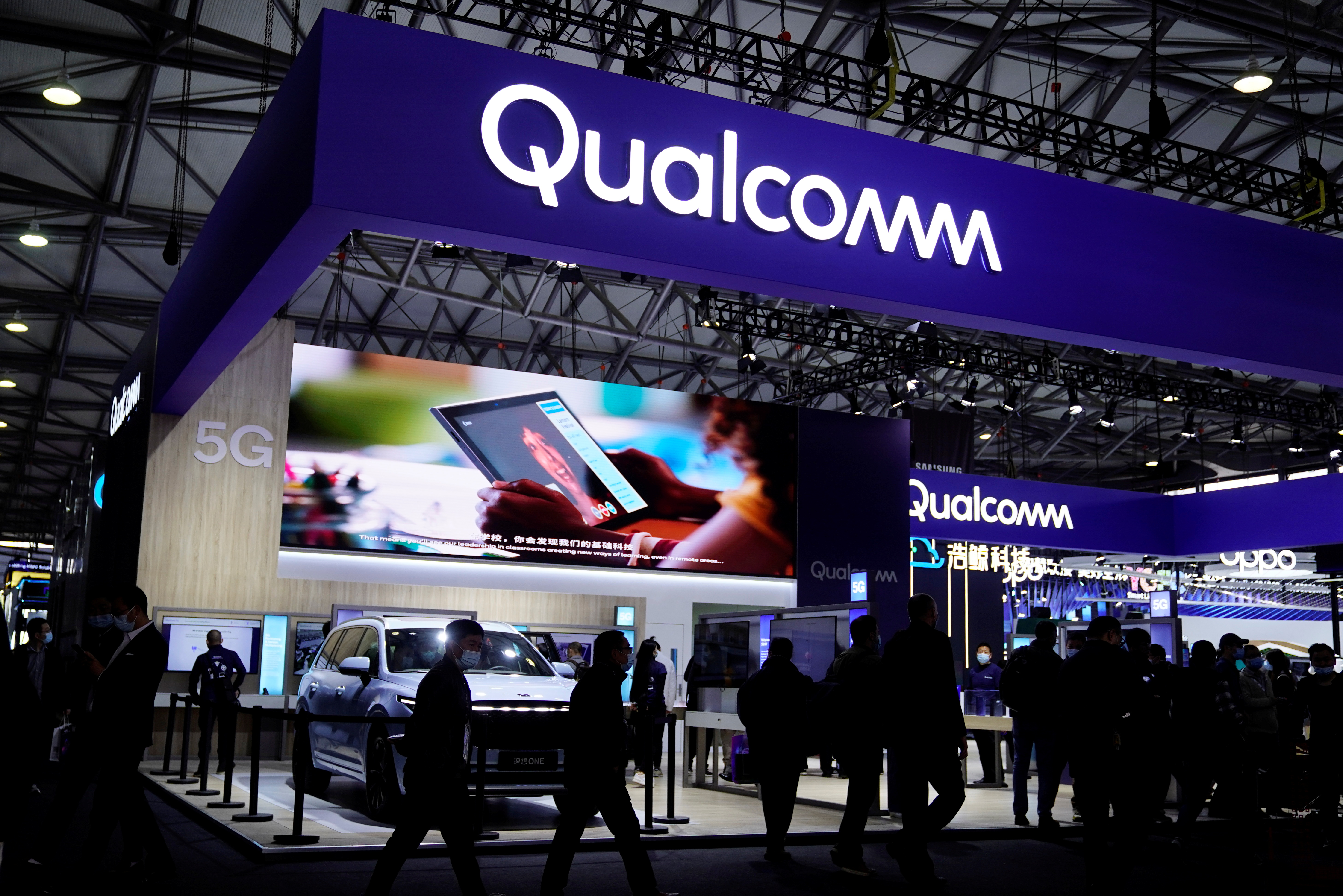 People visit a Qualcomm booth at the Mobile World Congress in Shanghai, February 23, 2021.