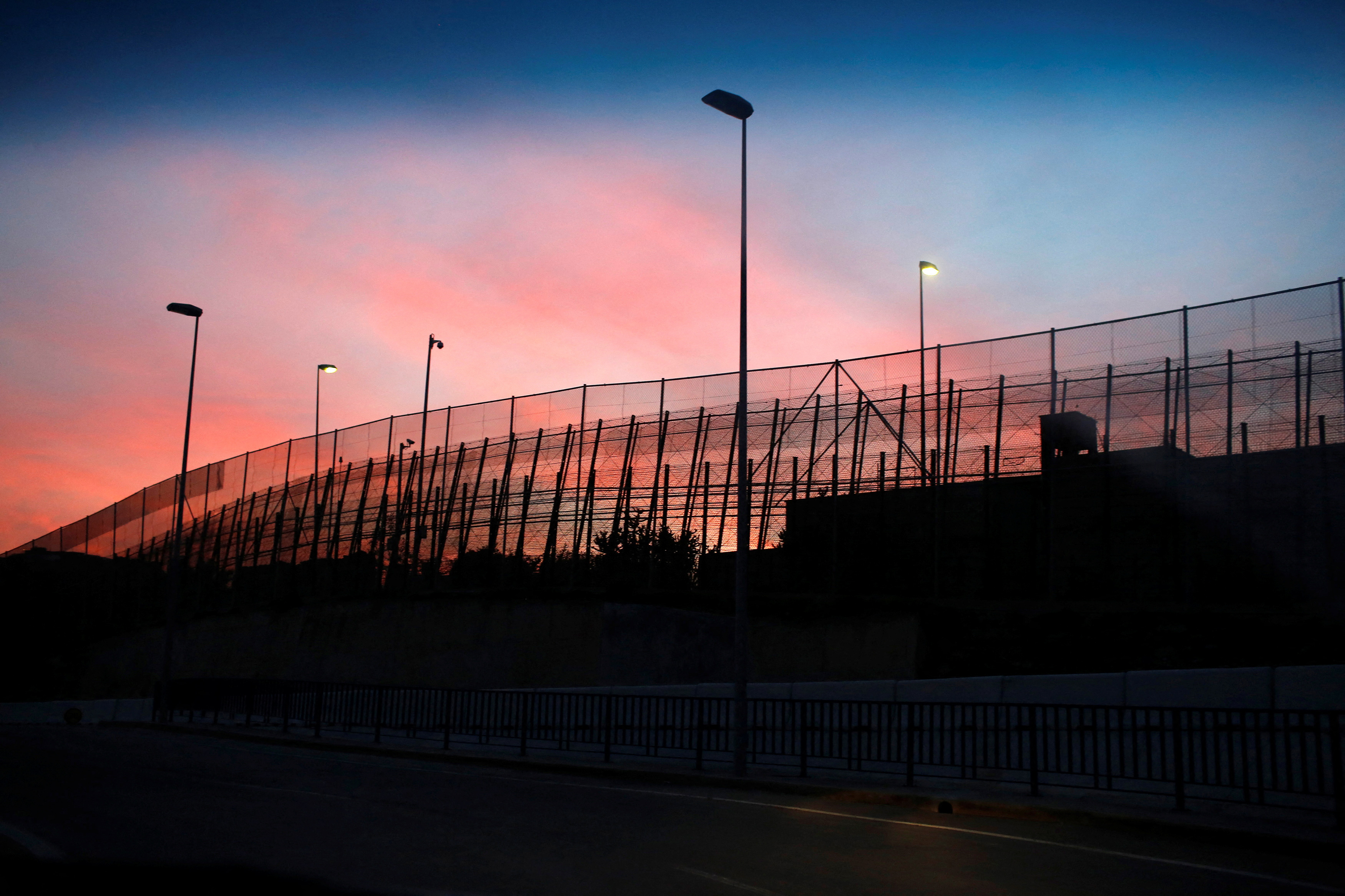 The border fence between Morocco and Spain's north African enclave Melilla is seen along a road