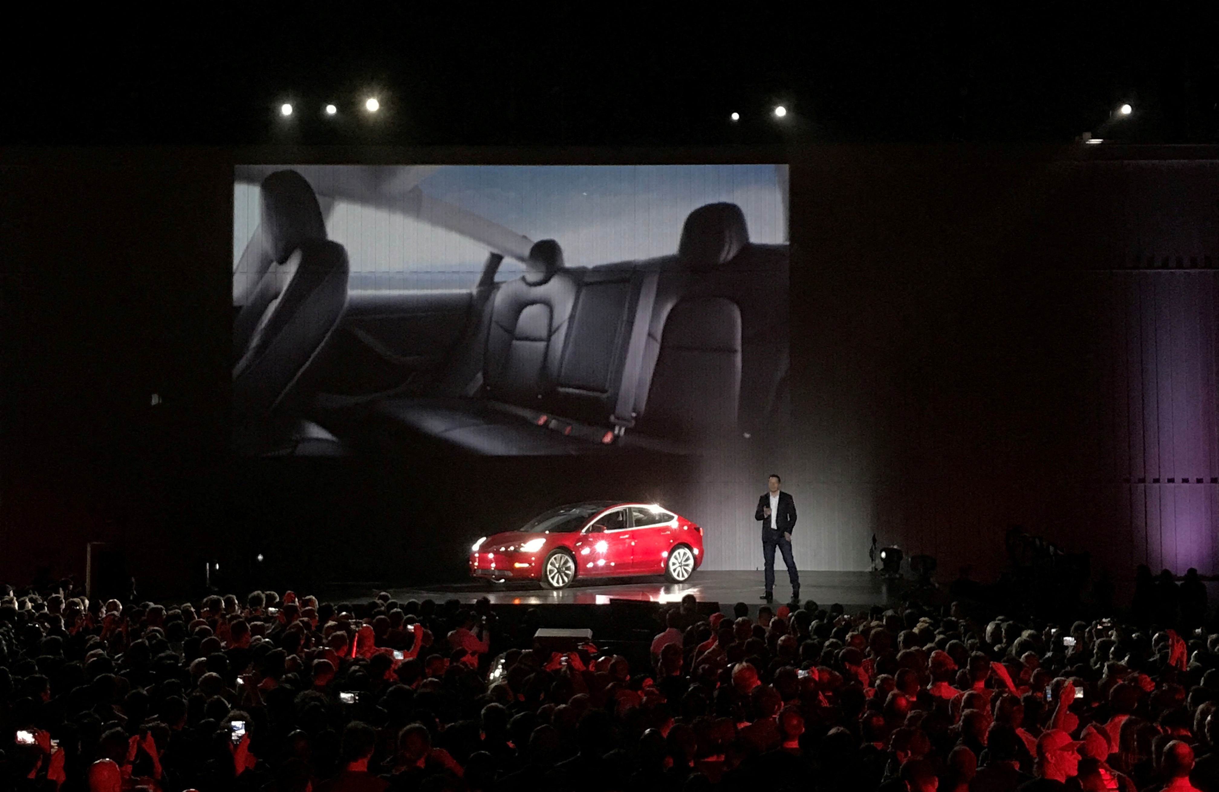 Tesla Chief Executive Elon Musk introduces one of the first Model 3 cars off the Fremont factory's production line during an event at the company's facilities in Fremont, California, U.S., July 28, 2017.     REUTERS/Alexandria Sage/File Photo