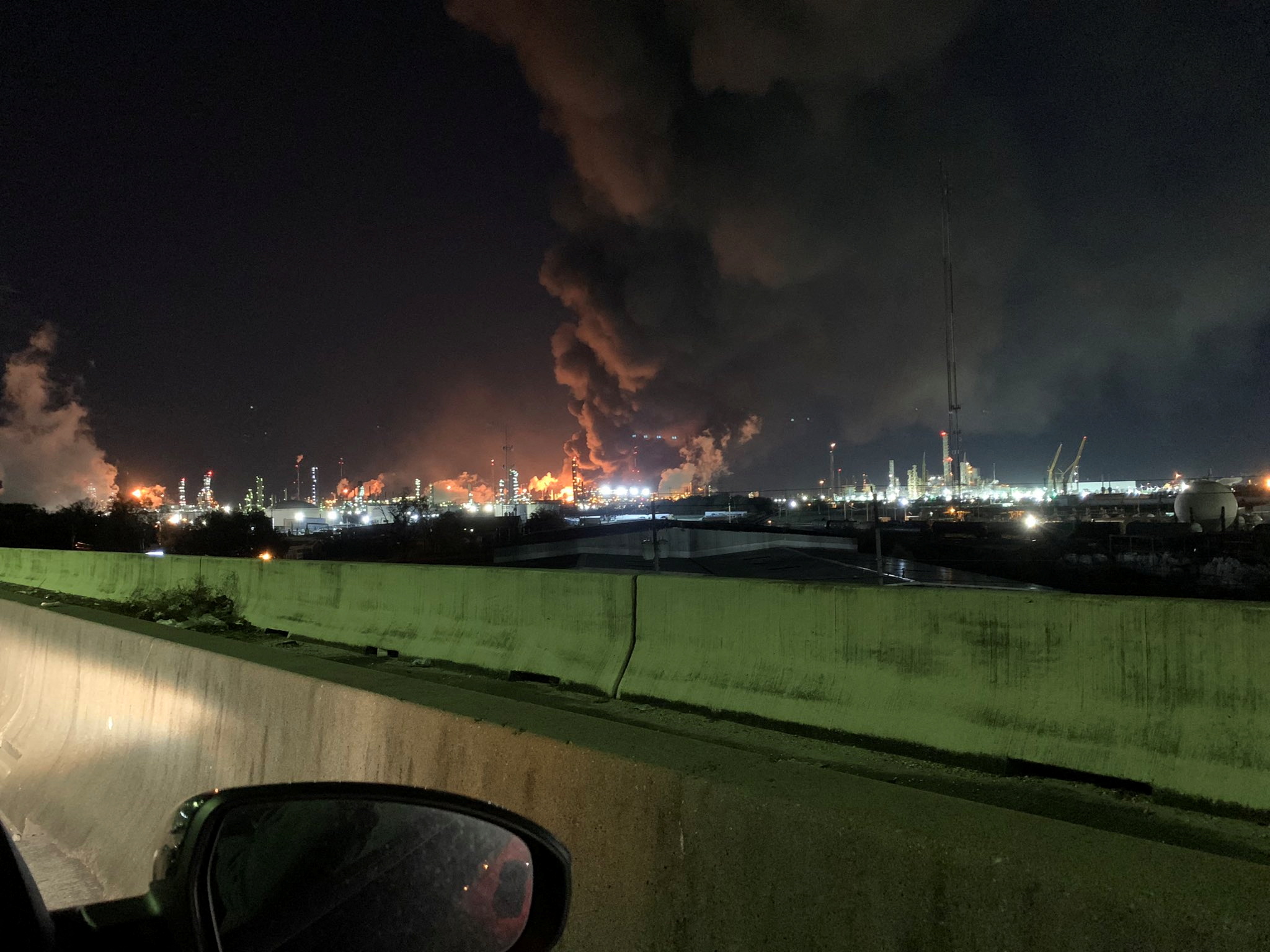 View from the road of a fire at petrochemical company ExxonMobil's refinery near Houston in Baytown, Texas, U.S., December 23, 2021 in this image obtained from social media. Molly Fitzpatrick via REUTERS 