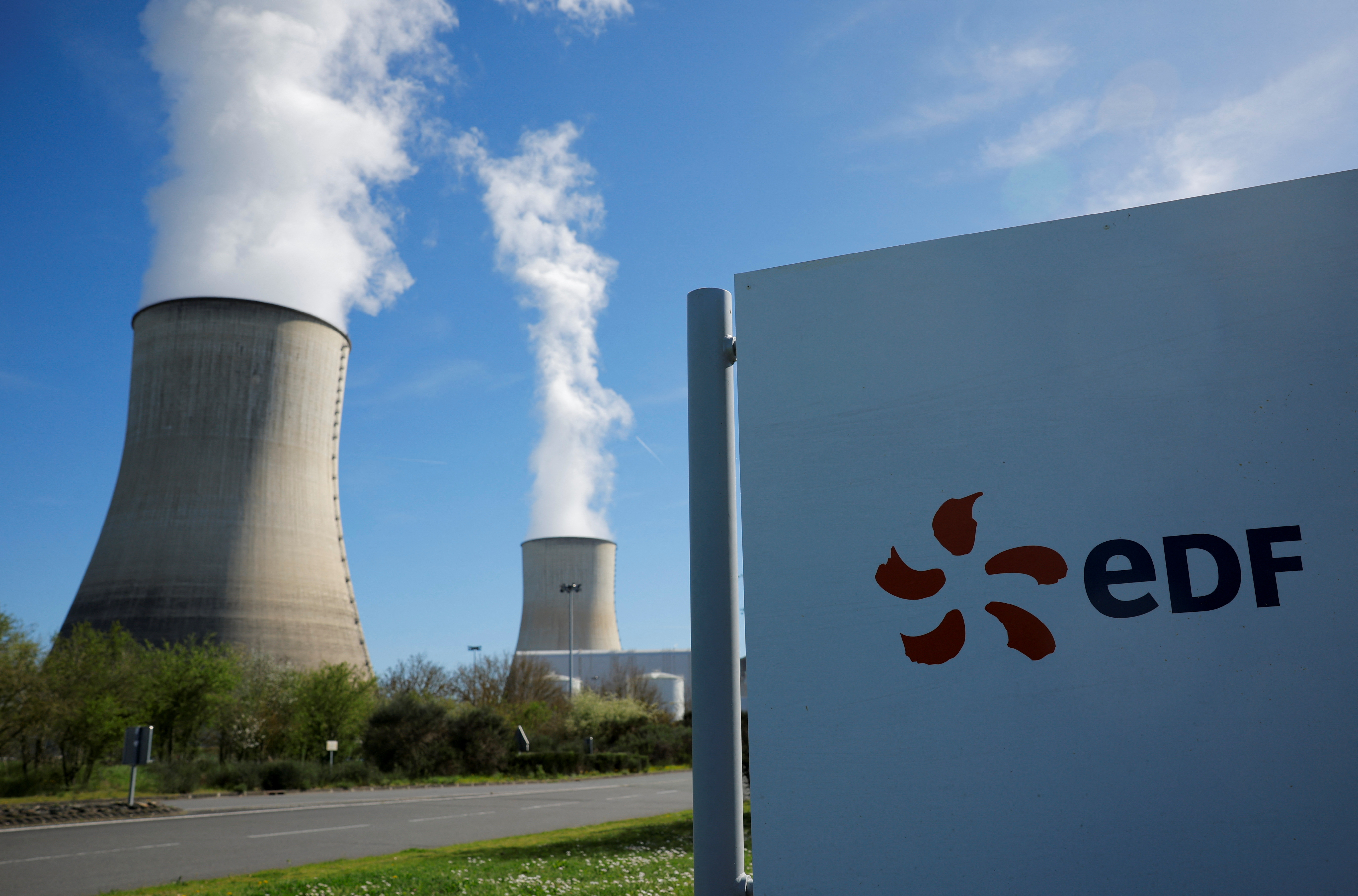The logo of Electricite de France (EDF) is seen in front of cooling towers at the entrance of the nuclear power plant site
