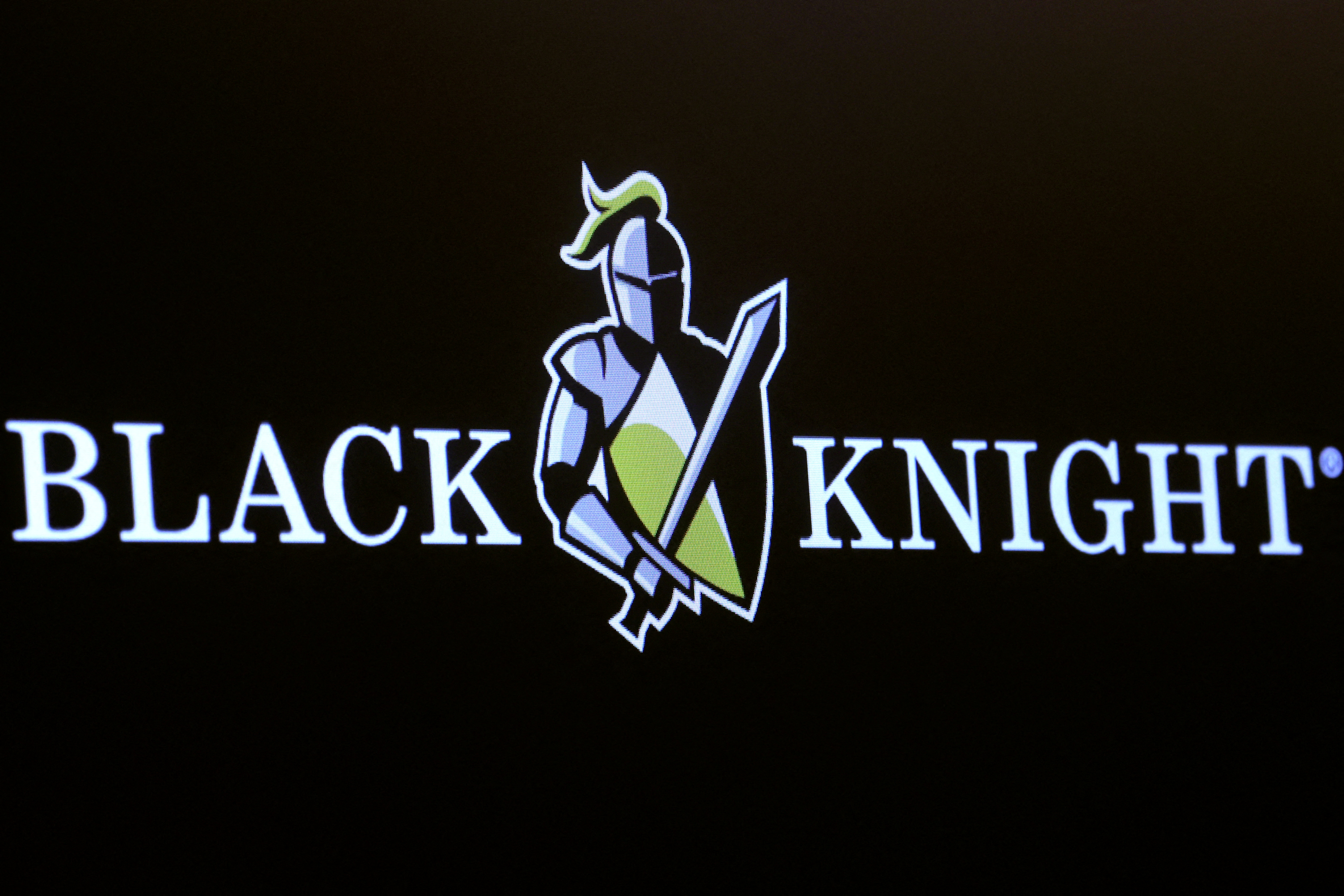 A screen displays the logo for Black Knight on the floor of the NYSE in New York