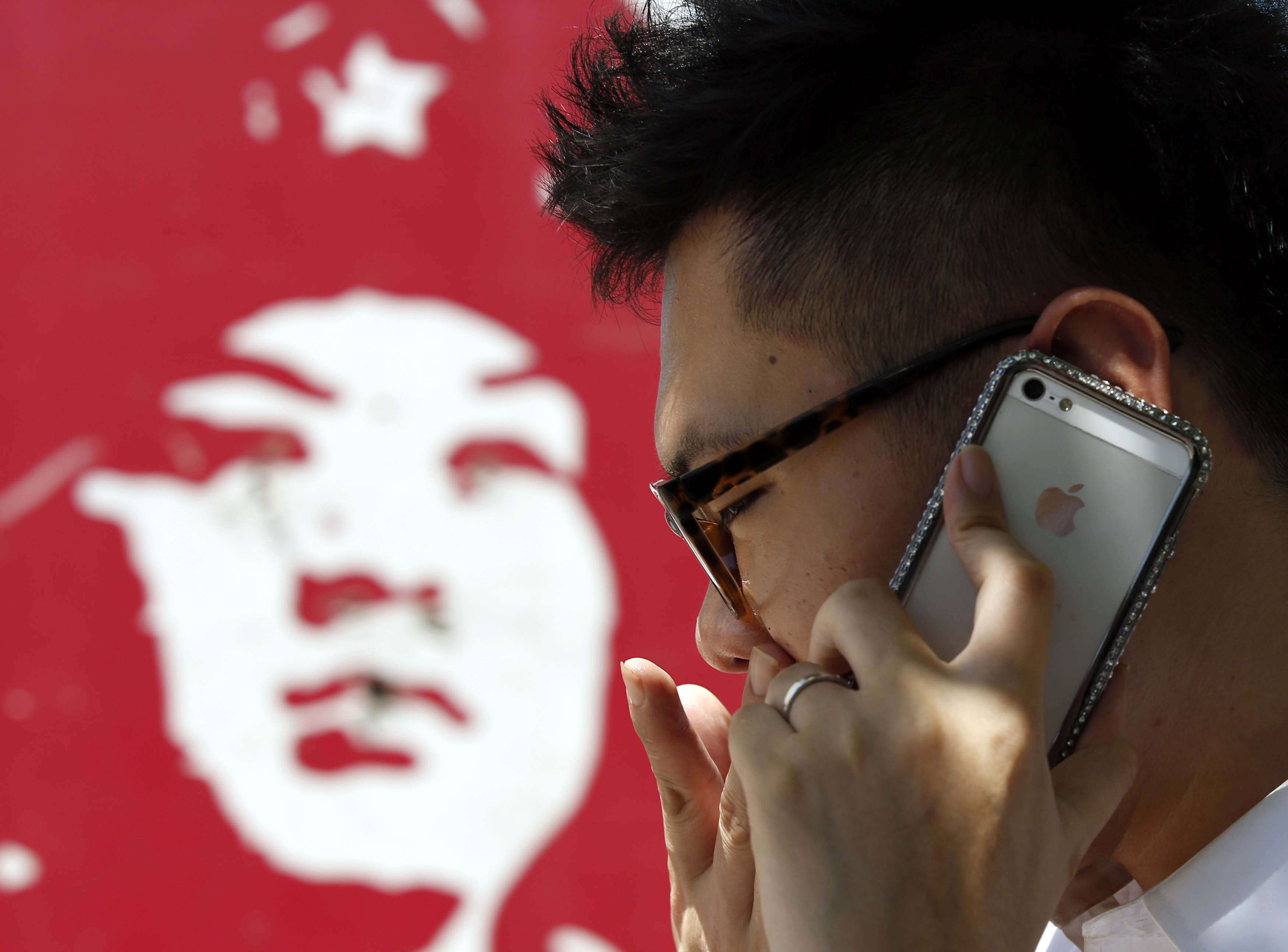 A man talks on an iPhone in Beijing