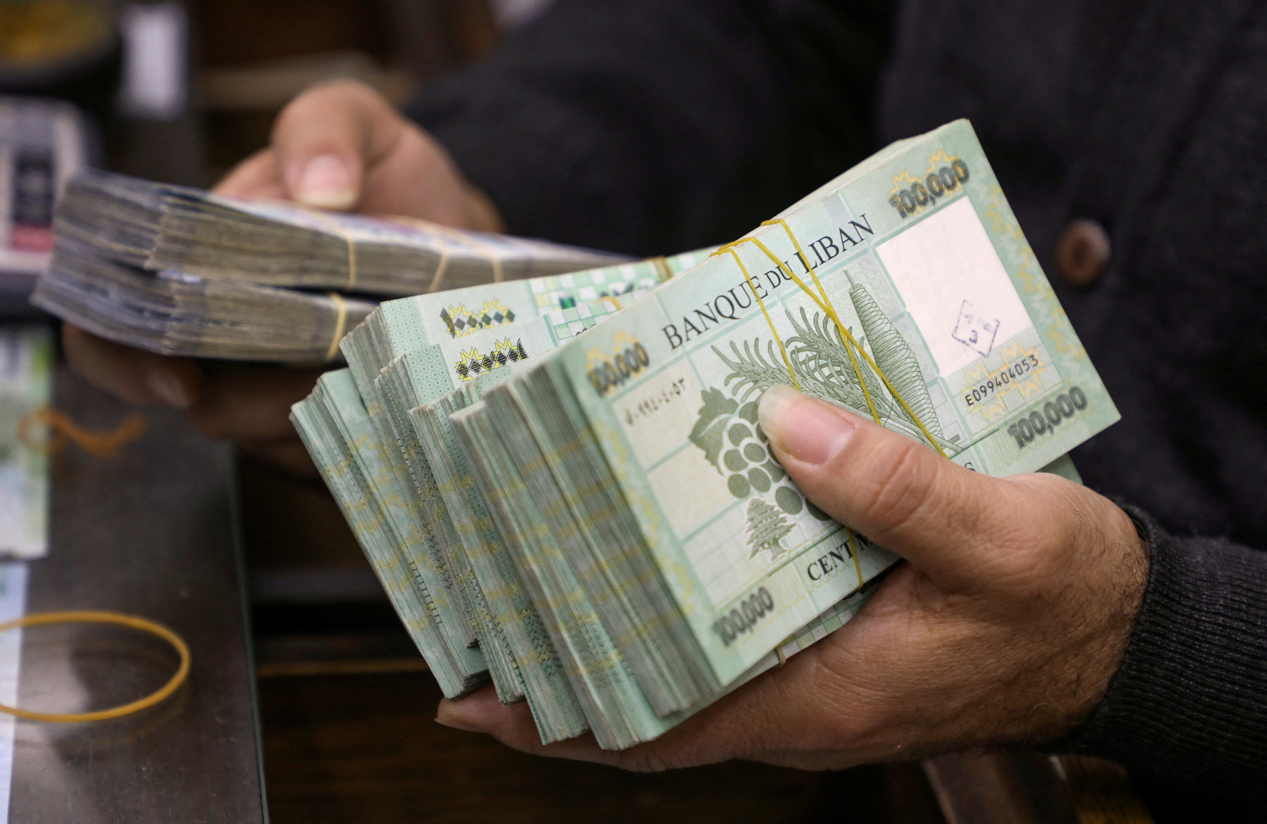 A money exchange vendor displays Lebanese pound banknotes at his shop in Beirut