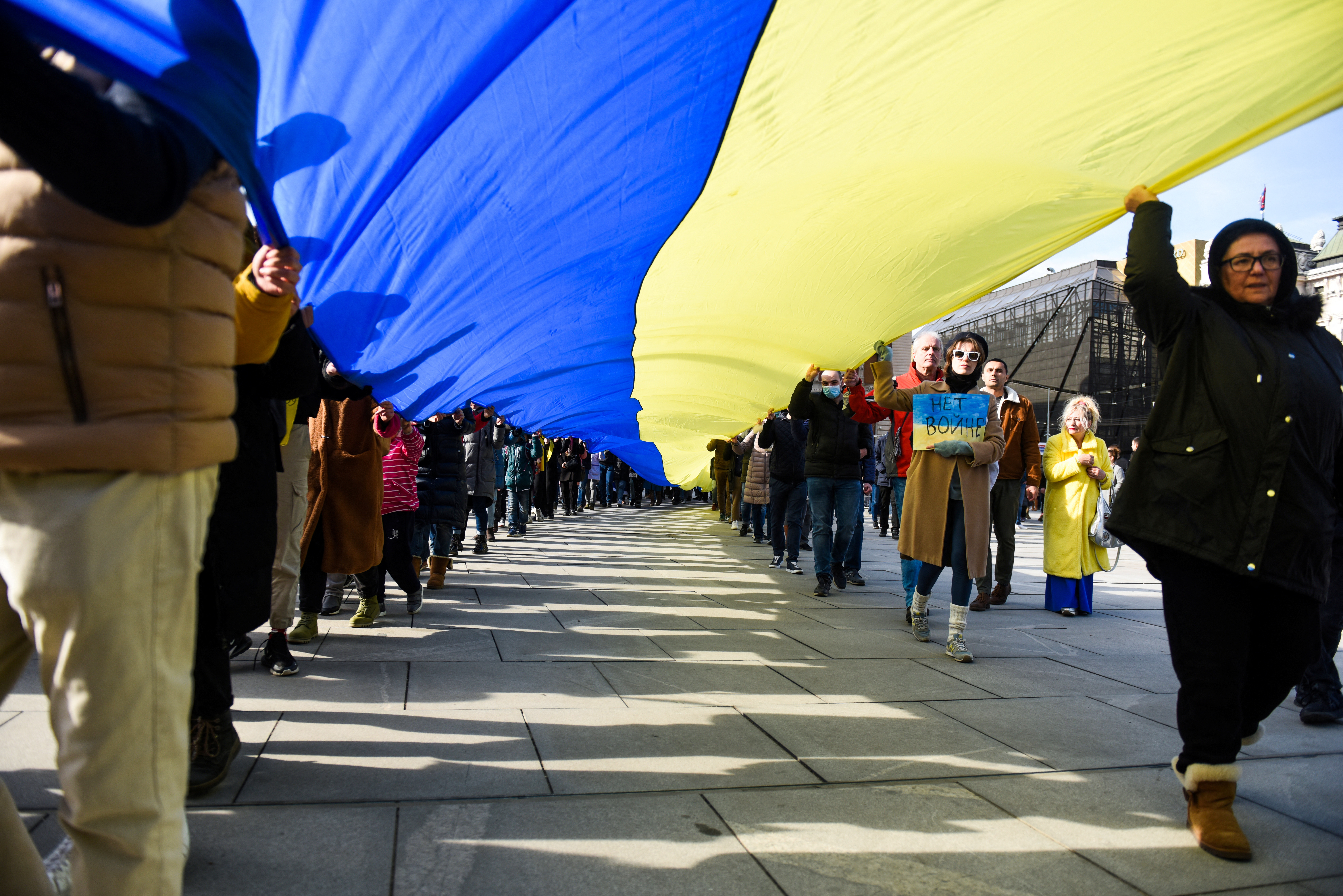 People take part in an anti-war protest, following Russia's invasion of Ukraine, in Belgrade