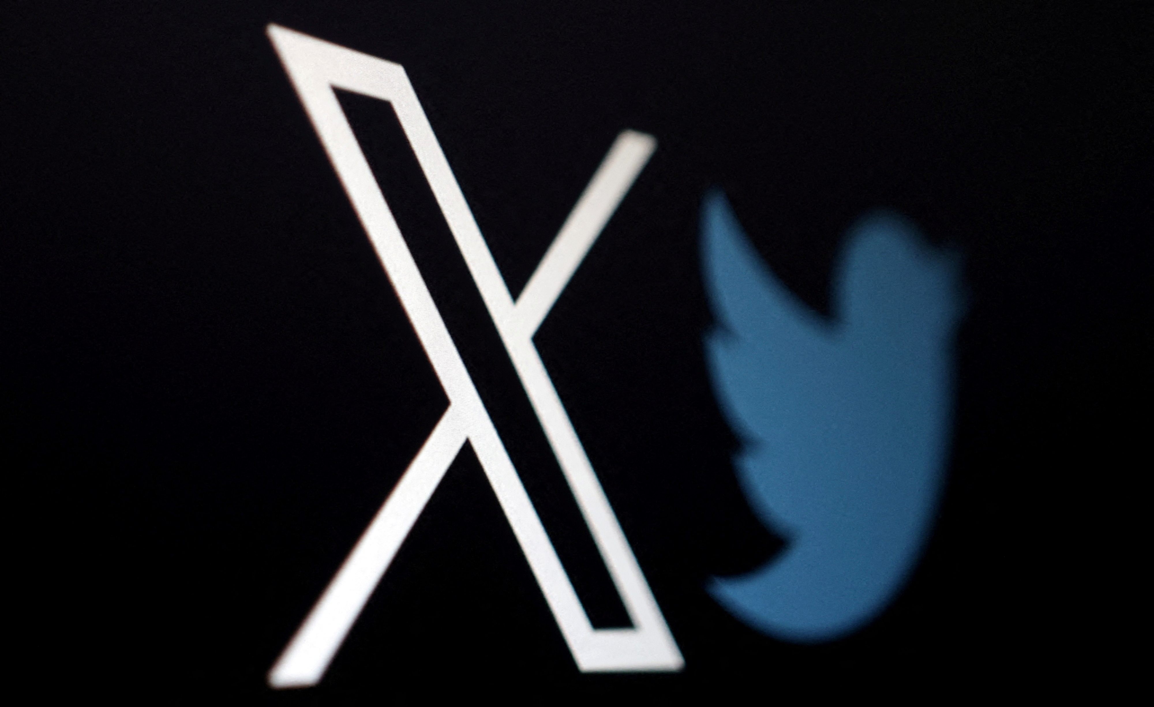 The logo of social media platform X, formerly Twitter, is seen alongside the former logo in this illustration taken, July 24, 2023. 