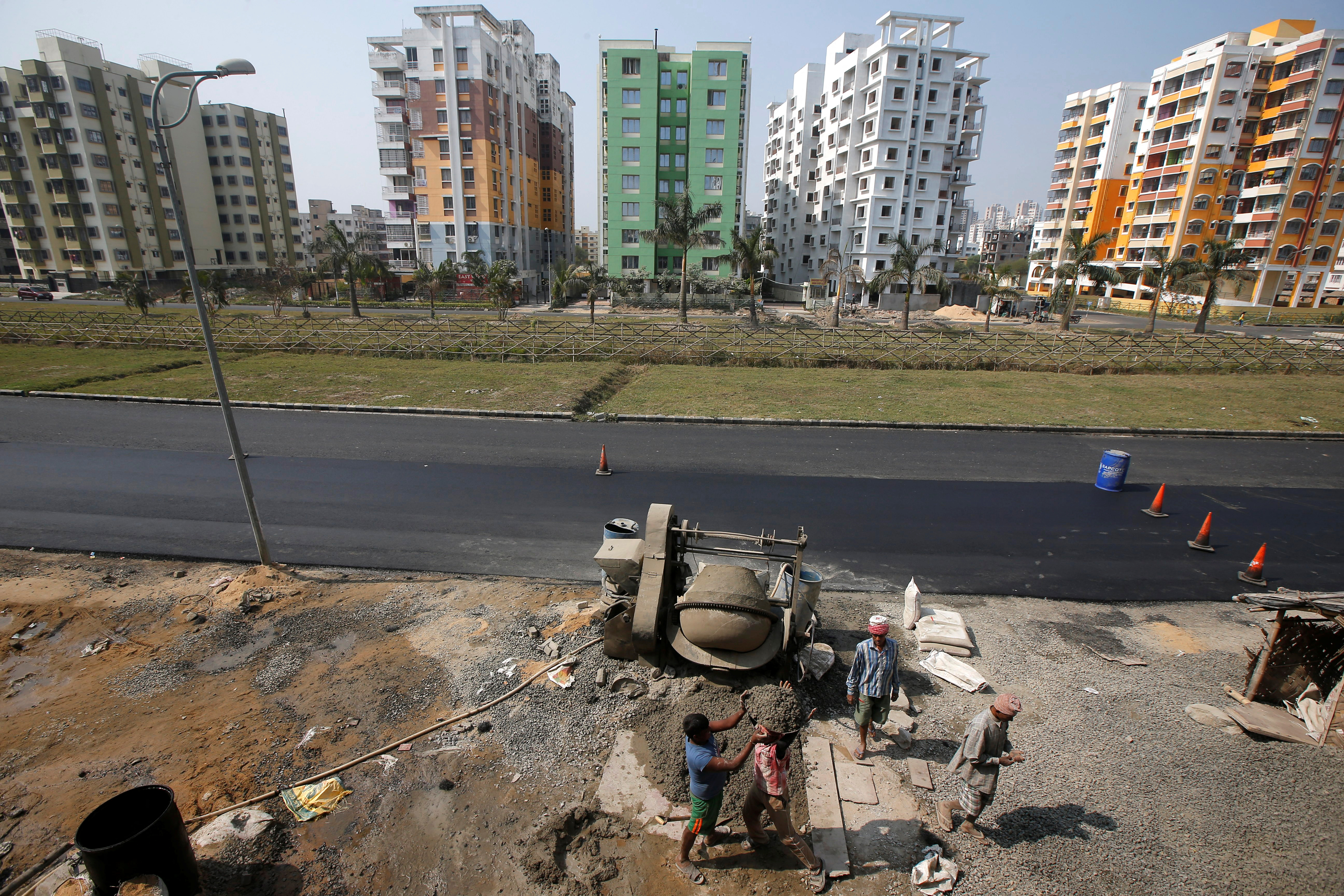 Labourers work at the construction site of a residential complex on the outskirts of Kolkata