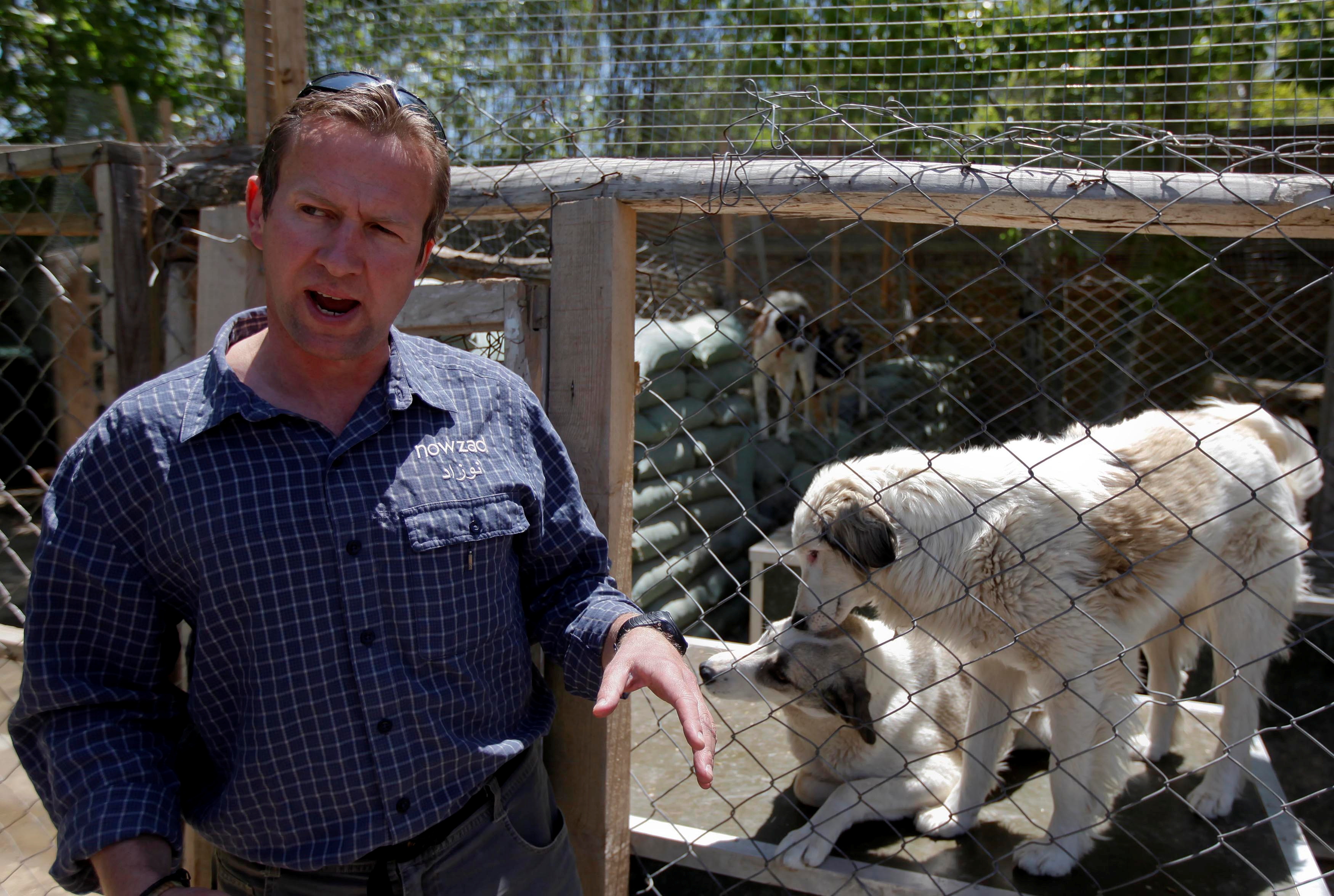Pen Farthing, founder of animal shelter Nowzad, stands in front of a cage in Kabul