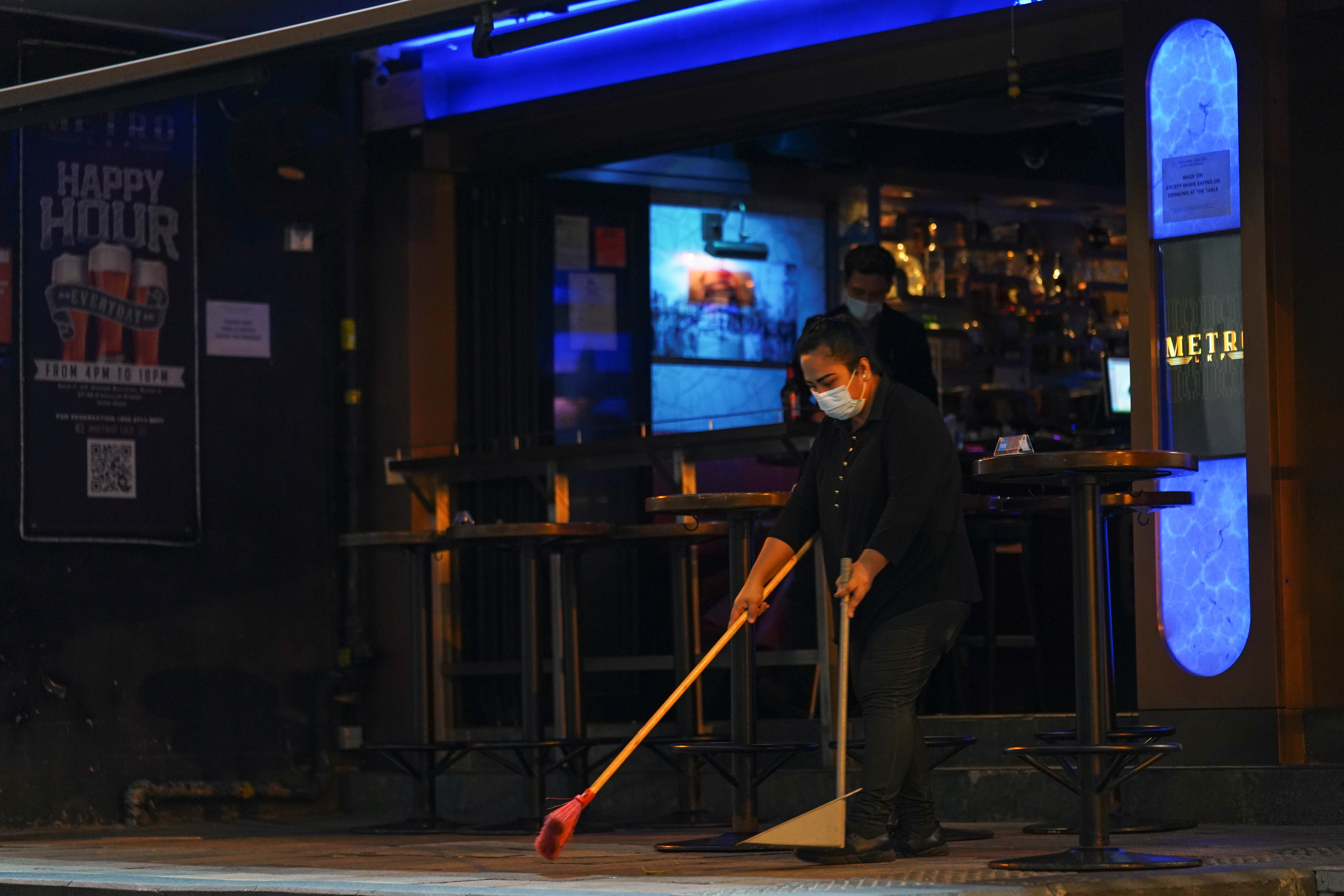 Staff cleans outside a bar in Hong Kong's Lan Kwai Fong