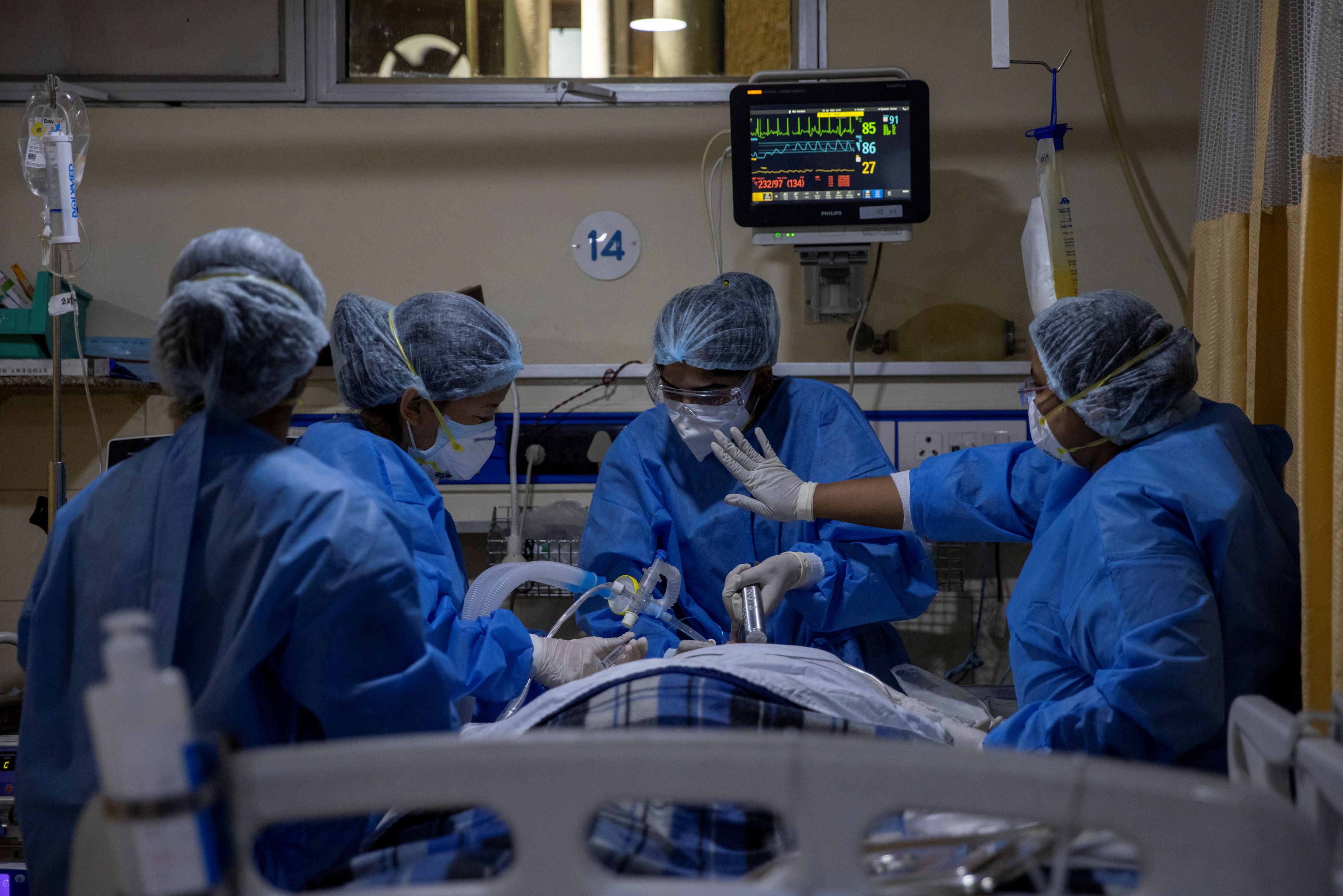India Covid cases cross 18 million, gravediggers work round the clock 6 Medical workers tend to a patient suffering from the coronavirus disease (COVID-19), inside the ICU ward at Holy Family Hospital in New Delhi, India, April 29, 2021. REUTERS/Danish Siddiqui