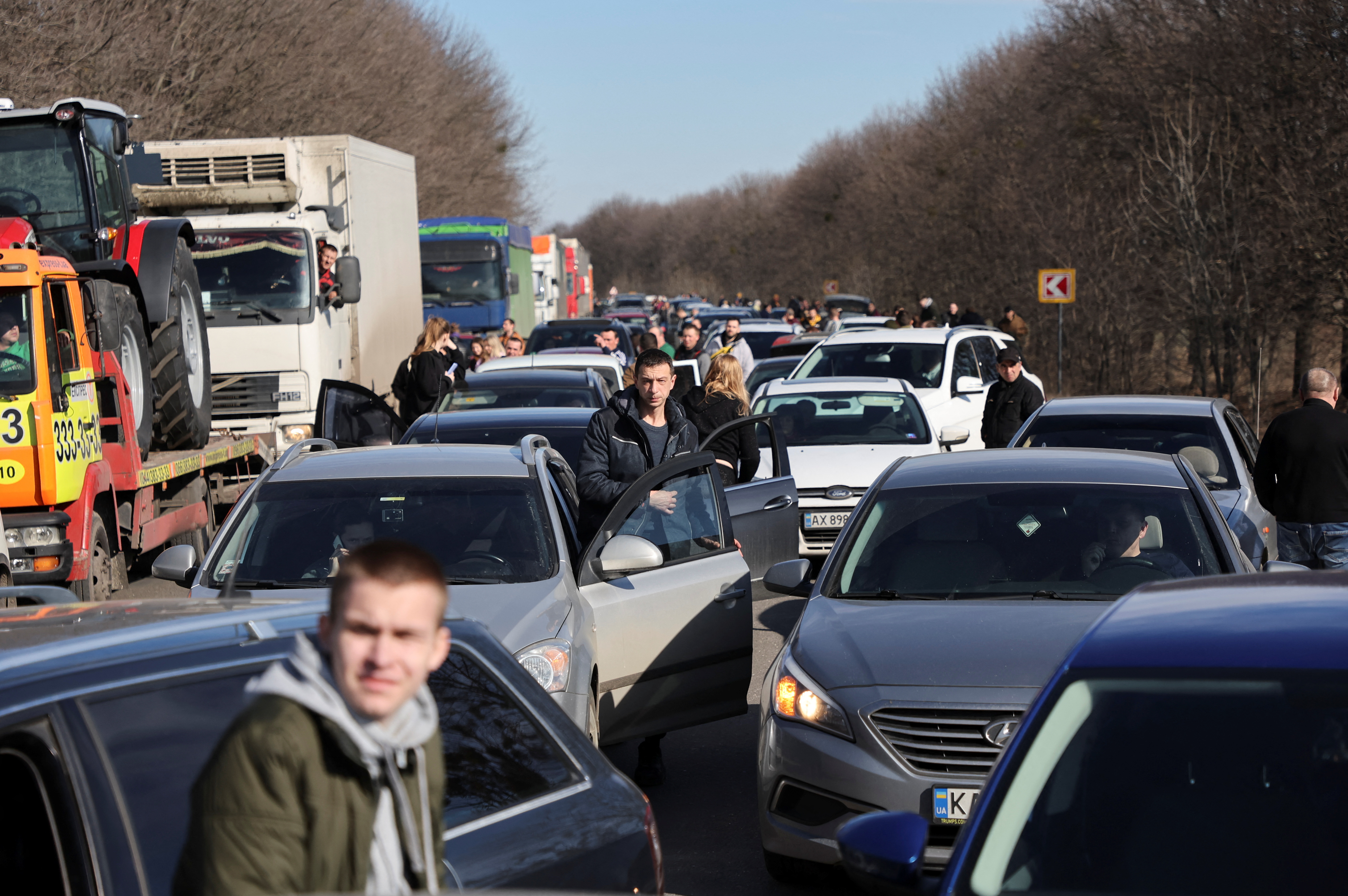 People wait in a traffic jam as they leave the city of Kharkiv, after Russian President Vladimir Putin authorised a military operation in eastern Ukraine, in Kharkiv region, Ukraine February 24, 2022. REUTERS/Antonio Bronic
